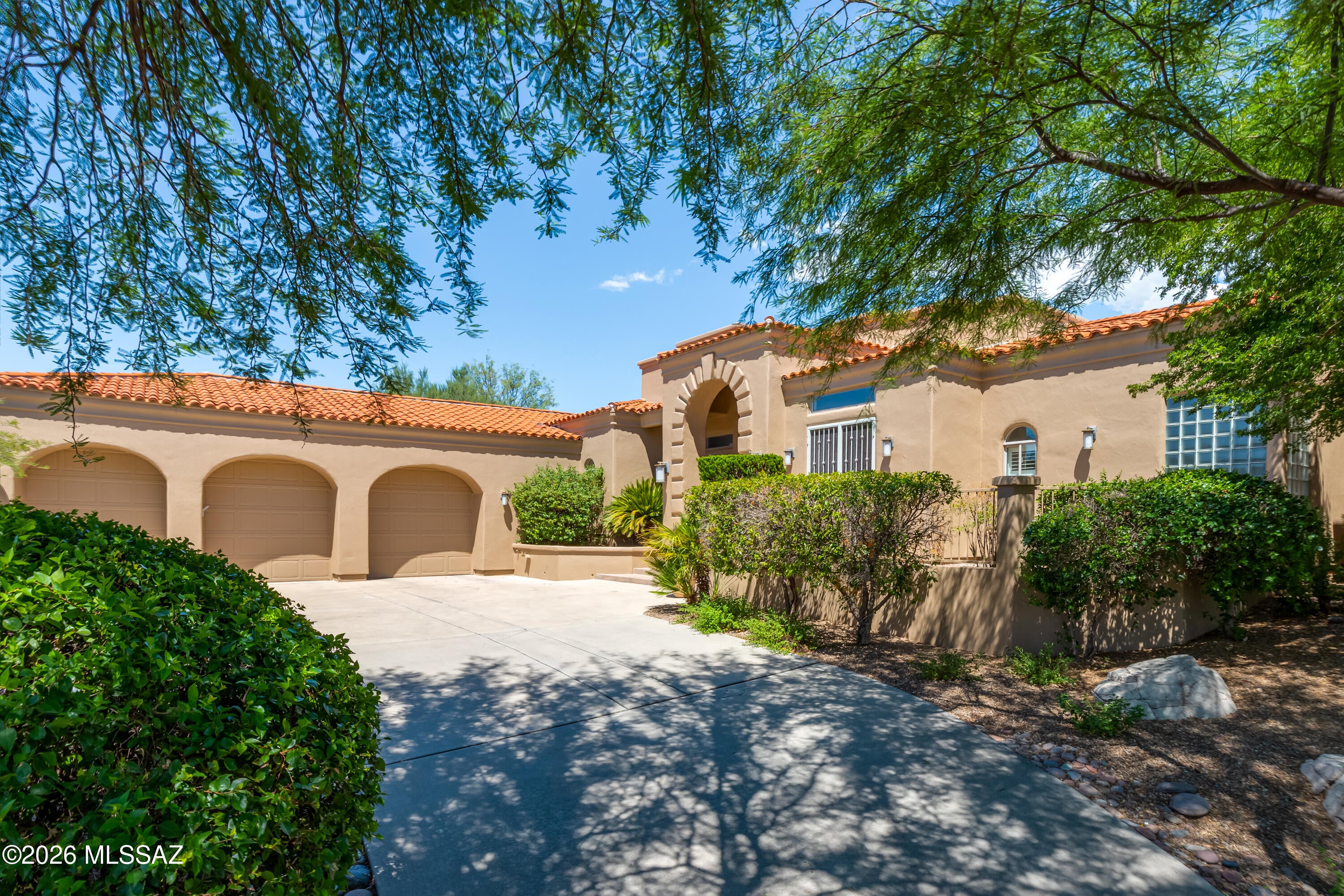 EXCEPTIONAL RENOVATED CUSTOM HOME IN GATED CANADA HILLS ESTATES! Extensively reimagined with more than $400,000 in renovations & improvements, this impressive 4,389sf residence combines sophisticated interiors, generous living spaces & resort-style outdoor living with beautiful mountain views. The versatile floor plan offers 4BR, 3Â½BA, dedicated office with private exterior entrance, media/game room with fireplace, formal living & dining rooms, spacious family room & oversized 3-car garage. The expansive primary suite occupies its own private wing & features a sitting area, 3-way fireplace, reading nook, large walk-in closet, abundant storage, dual vanities, generous walk-in shower & private patio/backyard access. Recent improvements include substantial investments in flooring, countertops, painting, bathrooms, closets, landscaping, HVAC & more. Step outside to your own private resort with a custom knife-edge pool ideal for lap swimming, plus diving board & slide, and a sport court ready for tennis, pickleball & basketball. Ideally located near Oro Valley recreation, golf, parks, shopping & dining. A rare opportunity offering extensive updates, privacy, mountain views, generous living spaces & exceptional amenities.