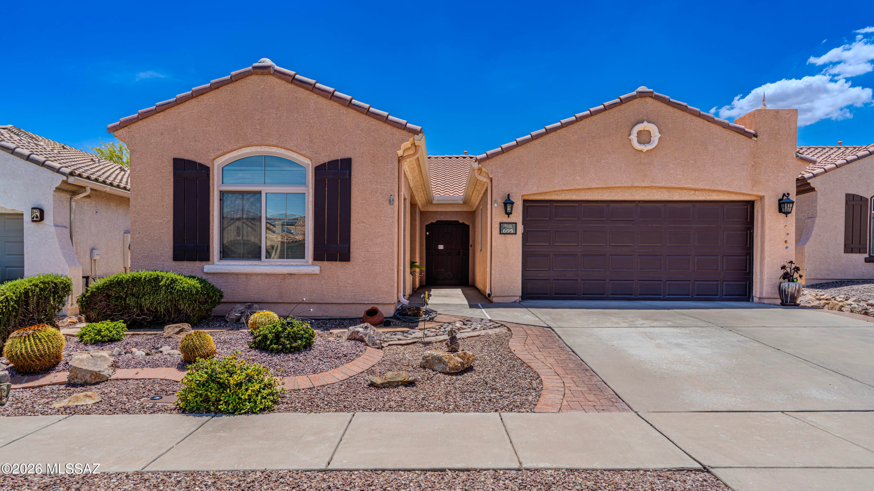 Beautifully maintained home offering upgraded features throughout in active adult living community! Enjoy the upgraded 20'' diagonal tile in the main living areas and a kitchen enhanced with slate-finish appliances, dual-oven range, refrigerator, a new stainless steel microwave with the stylish tile backsplash. Third bedroom boasts of useful cabinets for special projects, displays and more. This home also has a newer water heater and water softener. HVAC is approximately only 7 years old. Exterior improvements include a front security door, custom gutters, and a fully mature landscaped backyard designed for easy care and privacy. A rare third garage provides valuable extra storage, hobby space, or room for a golf cart.