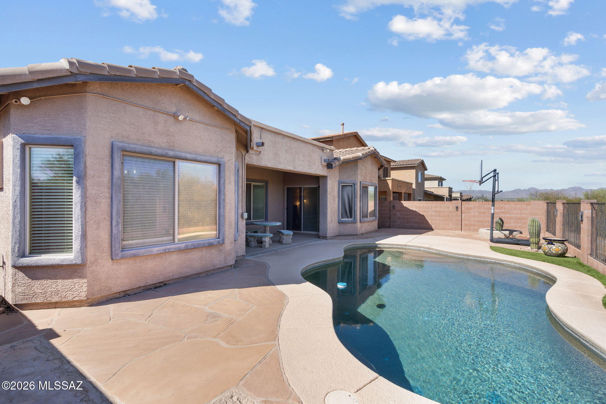 1% lender paid buy down available! Nestled in the highly desirable Continental Reserve community in northwest Tucson, this stunning single-story contemporary home offers 2,135 square feet of thoughtfully designed living space, featuring 4 bedrooms, 2 bathrooms, and a versatile bonus den. The open floor plan creates an inviting atmosphere throughout, anchored by a newly remodeled kitchen featuring an island breakfast bar and a spacious dining area perfect for both everyday living and entertaining. The primary suite serves as a true retreat, complete with dual vanity sinks, a relaxing soaking tub, a separate walk-in shower, and a generous walk-in closet. Step outside to enjoy the quintessential Arizona lifestyle with a covered patio, low-maintenance landscaping, and a sparkling private pool. The backyard features a view fence overlooking the open desert, offering both privacy and scenic views. With an HVAC system less than 2 years old, an existing solar system, ceiling fans, and central air throughout, energy efficiency and comfort are top priorities. Additional features include custom detailing, upgraded lighting, smart home conveniences, and a 3-car tandem garage. Located within the Marana Unified School District and just minutes from premier shopping, dining, recreation, and entertainment, this beautifully maintained home offers exceptional value in a thriving northwest Tucson neighborhood - an opportunity not to be missed.