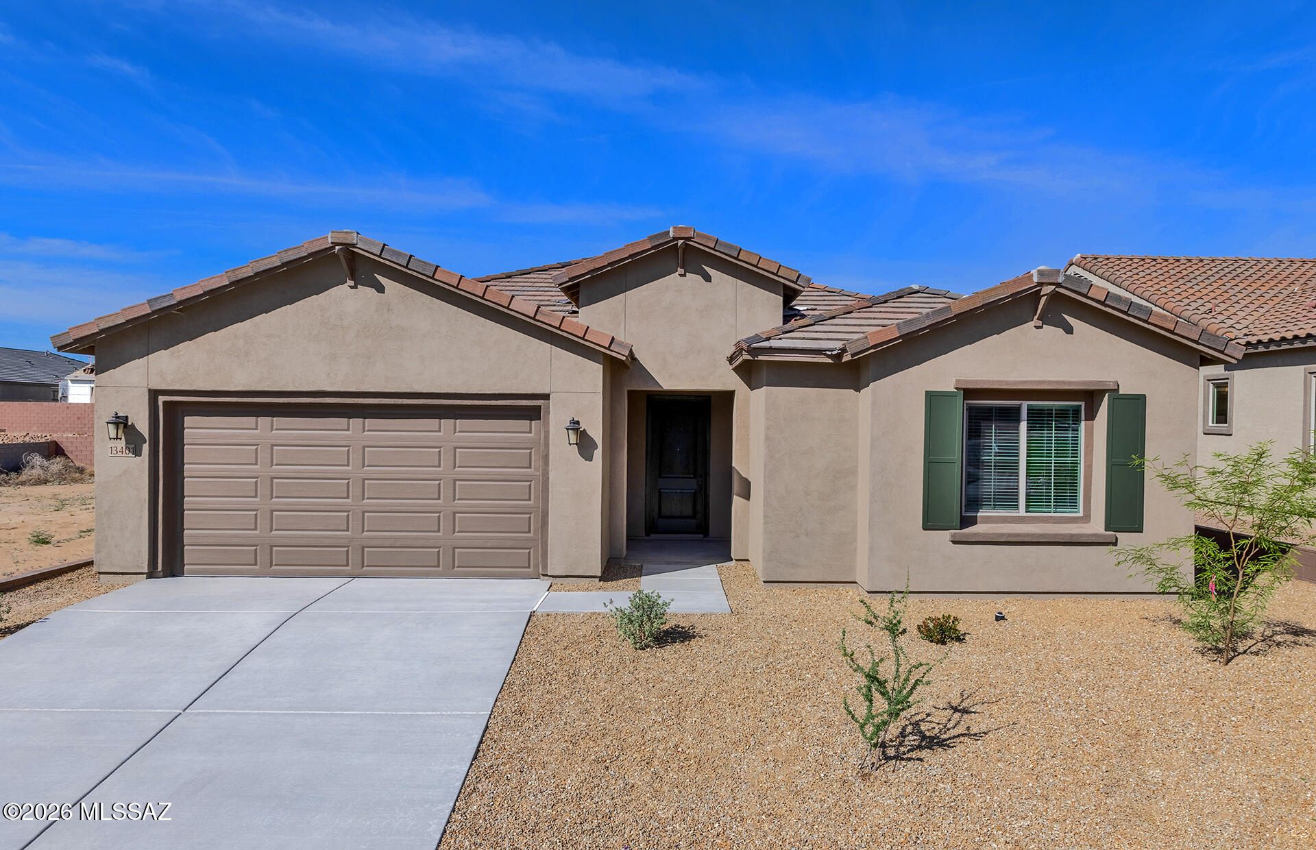 This designer home features a split floor plan with a contemporary exterior. Inside, enjoy a chef's kitchen with gas cooktop, stainless steel appliances, upgraded Coastal Shaker maple cabinets, Lime Delight quartz counters, and a single basin sink. The owner's bath offers a low-threshold walk-in shower and matching quartz. Additional upgrades include 24x24 Moroccan concrete flooring, tankless water heater, dual-pane windows, and more.