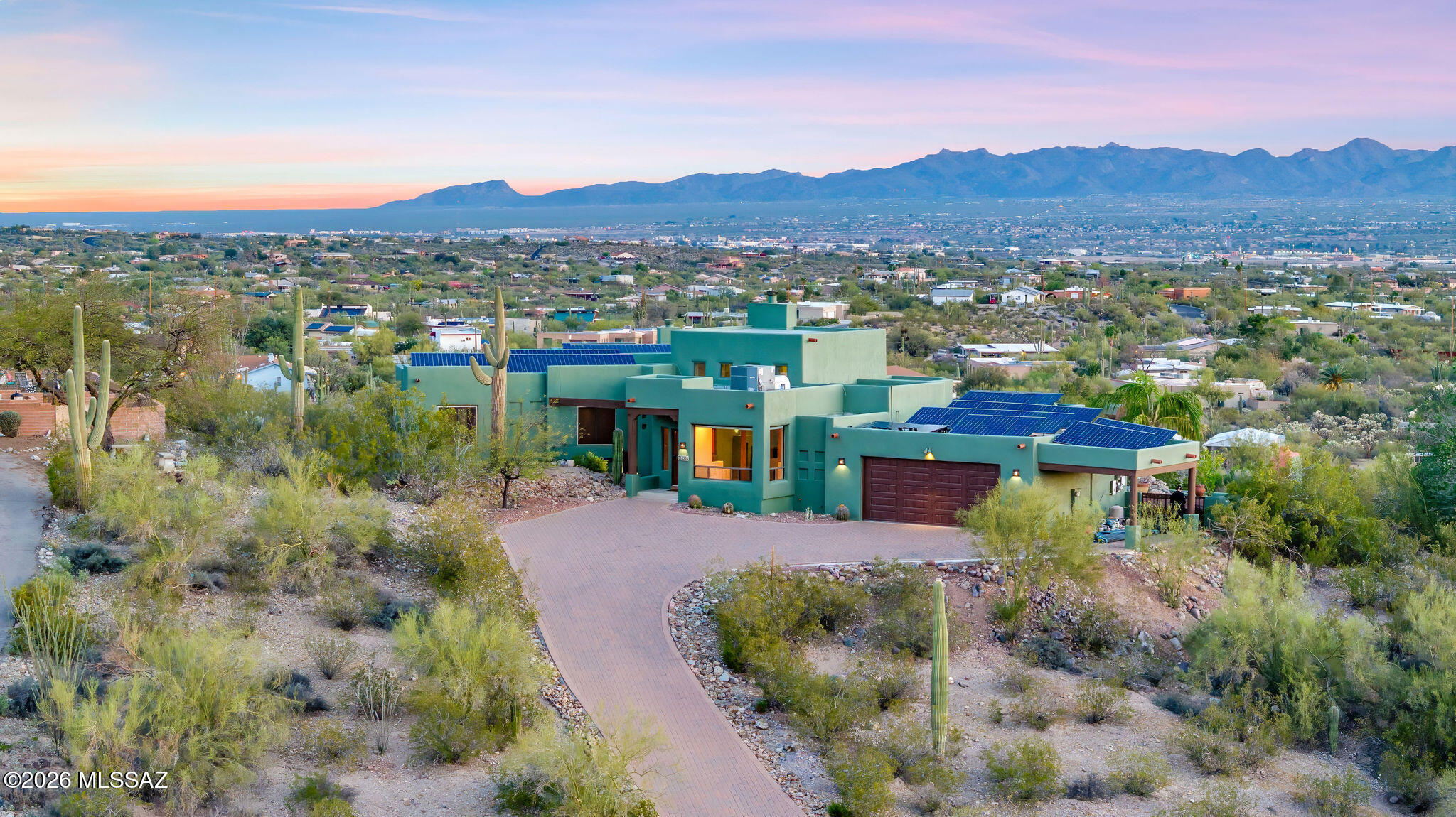 Open the door of this custom ridge top Santa Fe and you'll be amazed at the breathtaking views that lie before you! Character abounds from the gorgeous Saltillo tile floors, to the dramatic viga and pecky cedar ceilings. You'll love the primary suite from the custom updated bathroom to wood viga ceilings, cozy beehive fireplace and spectacular views of the sparkling pool, twinkling city lights and majestic Catalina mountains. Entertain your friends on the lovely patio with breath-taking eagle's nest views, an inviting beehive fireplace, built in BBQ and refreshing pebble tec pool! A rare and treasured desert sanctuary! Take advantage of the pre-paid solar lease, that has been paid in full for the remainder of the leased contract which expires in 2035