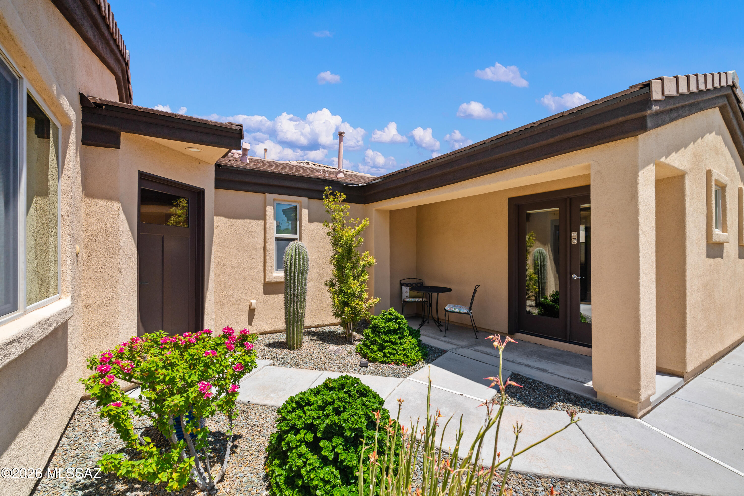 Unexpected Gem! Review the pictures and take a tour, the property speaks for itself. Even though it already has a great outdoor kitchen, firepit pub table, garden boxes, mature landscape, pavers and turf, there is still space on the lot for a pool, additional casita or garage, should you choose to expand, and the drive gate is ready to use. Everything is top of the line from the upgraded Cabinets and Countertops throughout, to the Gourmet Appliances, Solid Knotty Alder Doors and Custom tile. Casita with private entrance for those late-night guests, or for a private office space, makes this place a cut above.