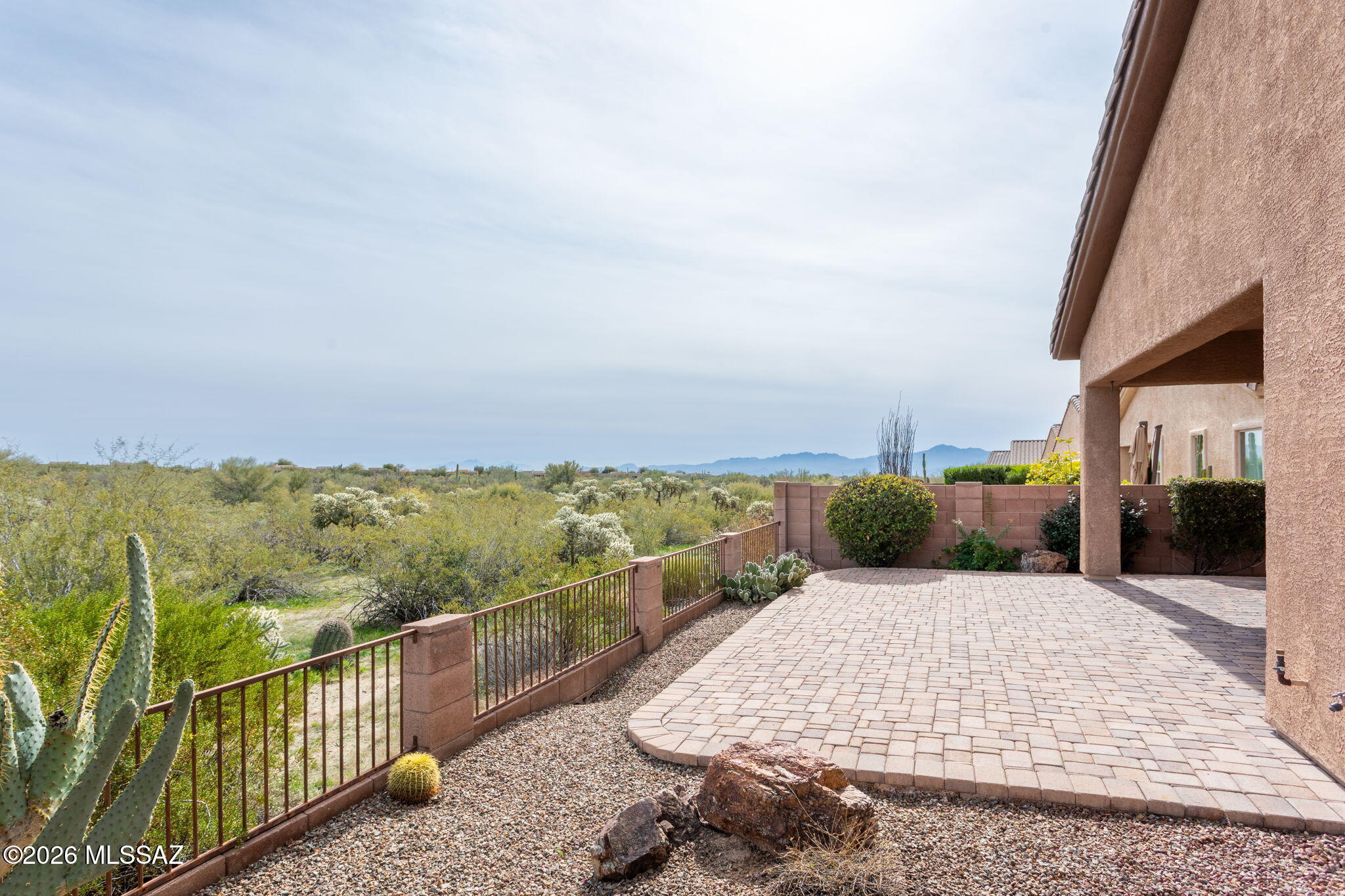 Welcome to Gentle Rain! The setting delivers peaceful desert surroundings while benefiting from a more accessible, convenient gated location within the community—ideal for buyers who value both tranquility and ease of access.This residence offers a generous 2,353 sqft, gorgeous travertine floors, split bedroom floor plan with 3 bedrooms and 2.5 baths. The flexibility of this space is unmatched with the open concept layout throughout. The large great room features a cozy gas fireplace and dining area which is flanked between the spacious kitchen perfect for gathering and entertaining around the island, as well as immediate access to the back covered patio. The primary suite has brand new carpet, large bathroom with dual vanities, walk in closet and private patio access to the backyard... The magic in the backyard speaks for itself - east facing with stunning unobstructed views of the Catalina Mountains; and the cherry on top, the property backs to open preserves. Notable items not to overlook, 2 newer HVAC units and newer water heater, indoor and outdoor automated sunscreens, and water treatment system. This home combines comfort, efficiency, all located within a highly desirable area close to restaurants, shopping, golf, I-10 access, you name it!