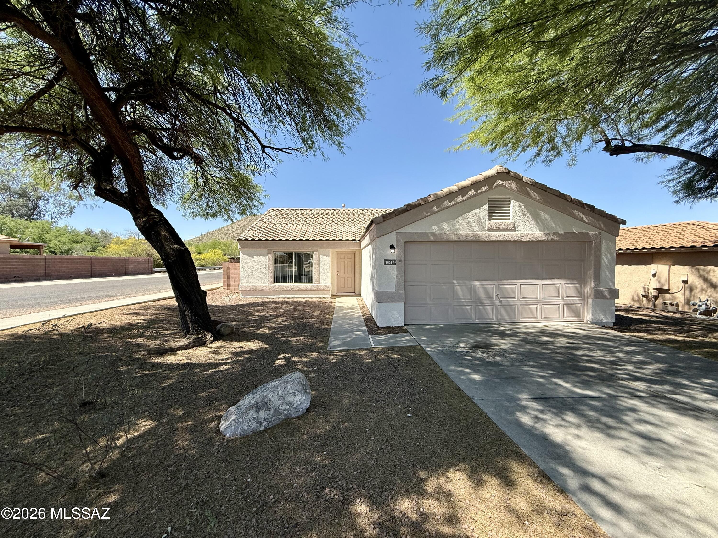This 1,364 square foot single-story home features 3 bedrooms and 2 bathrooms in the desirable Starr Pass Shadows neighborhood. The kitchen comes equipped with essential appliances including a dishwasher, oven, and refrigerator, providing everything you need for daily living. The open layout maximizes the available space, creating a comfortable flow throughout the home. The primary bedroom offers a private retreat with an ensuite bathroom, while two additional bedrooms provide flexibility for family, guests, or a home office. The second full bathroom serves the common areas and guest bedrooms conveniently. A dedicated laundry area adds to the home's functionality, though tenants will need to provide their own washer and dryer. The property includes a single-car garage for secure parking and storage. The home features central air conditioning to keep you comfortable year-round in the Arizona climate. Located in Starr Pass Shadows, this neighborhood offers a peaceful residential setting while maintaining convenient access to Tucson's amenities. The area provides easy access to shopping, dining, and recreational opportunities throughout the greater Tucson area. The single-story layout eliminates stairs and provides easy accessibility throughout the home. Built in 2001, this well-maintained property offers modern conveniences in an established neighborhood setting. The location provides a perfect balance of suburban tranquility while remaining connected to urban conveniences and employment centers throughout Tucson.