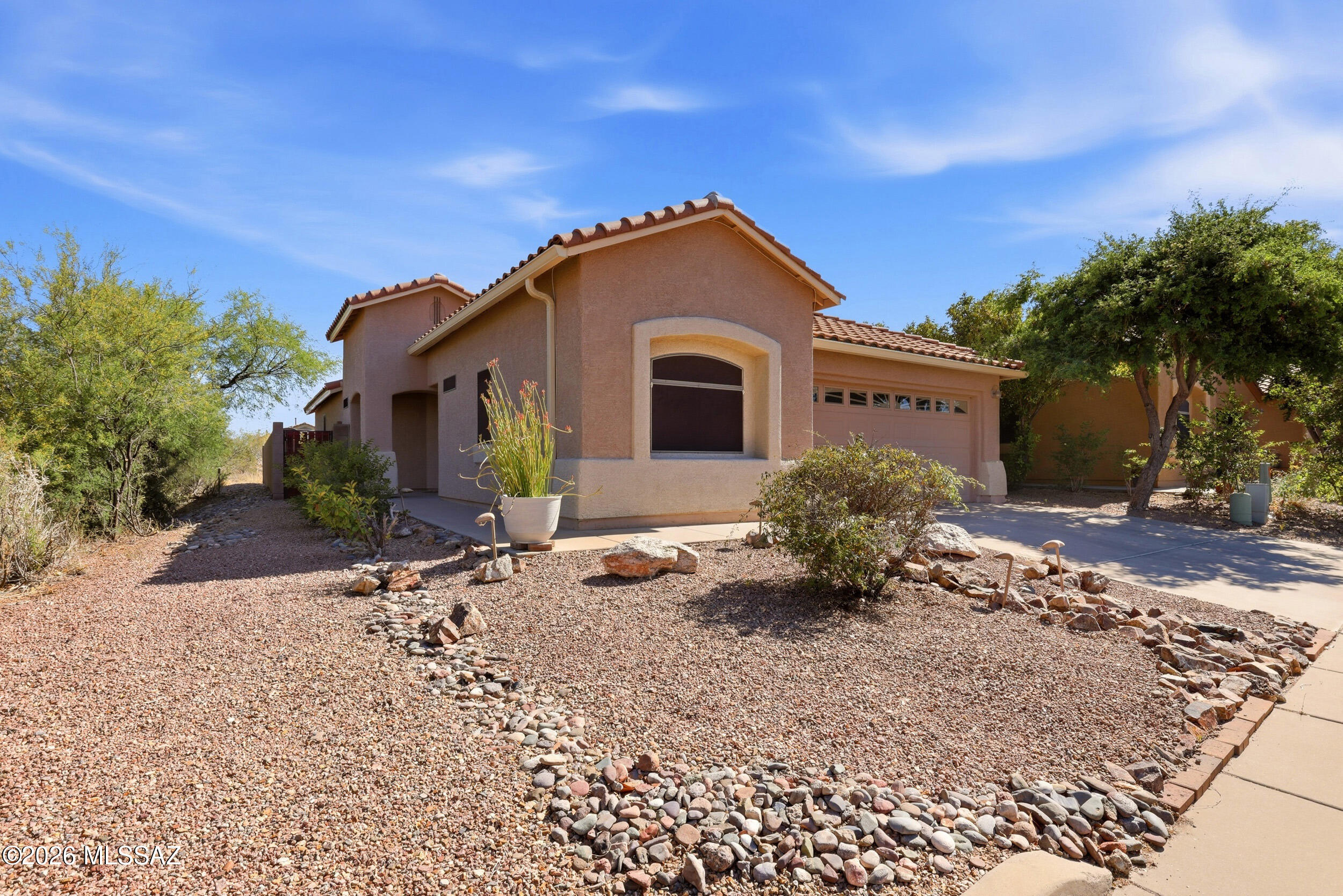 Beautifully maintained 3-bedroom, 2-bath home with 1,601 sq. ft. on a desirable corner lot in Tucson's sought-after Vail area. Surrounded by a large desert greenbelt, this property offers privacy, open space, and natural Sonoran beauty right outside your door. Inside, enjoy beautiful laminate flooring, a recently updated primary bathroom, and clear pride of ownership throughout. Major updates include a newer AC/heater and newer water heater for added peace of mind. The community features two pools, two parks, and a basketball court, creating the perfect balance of comfort, recreation, and desert living. A fantastic opportunity in a location that feels open, peaceful, and connected.