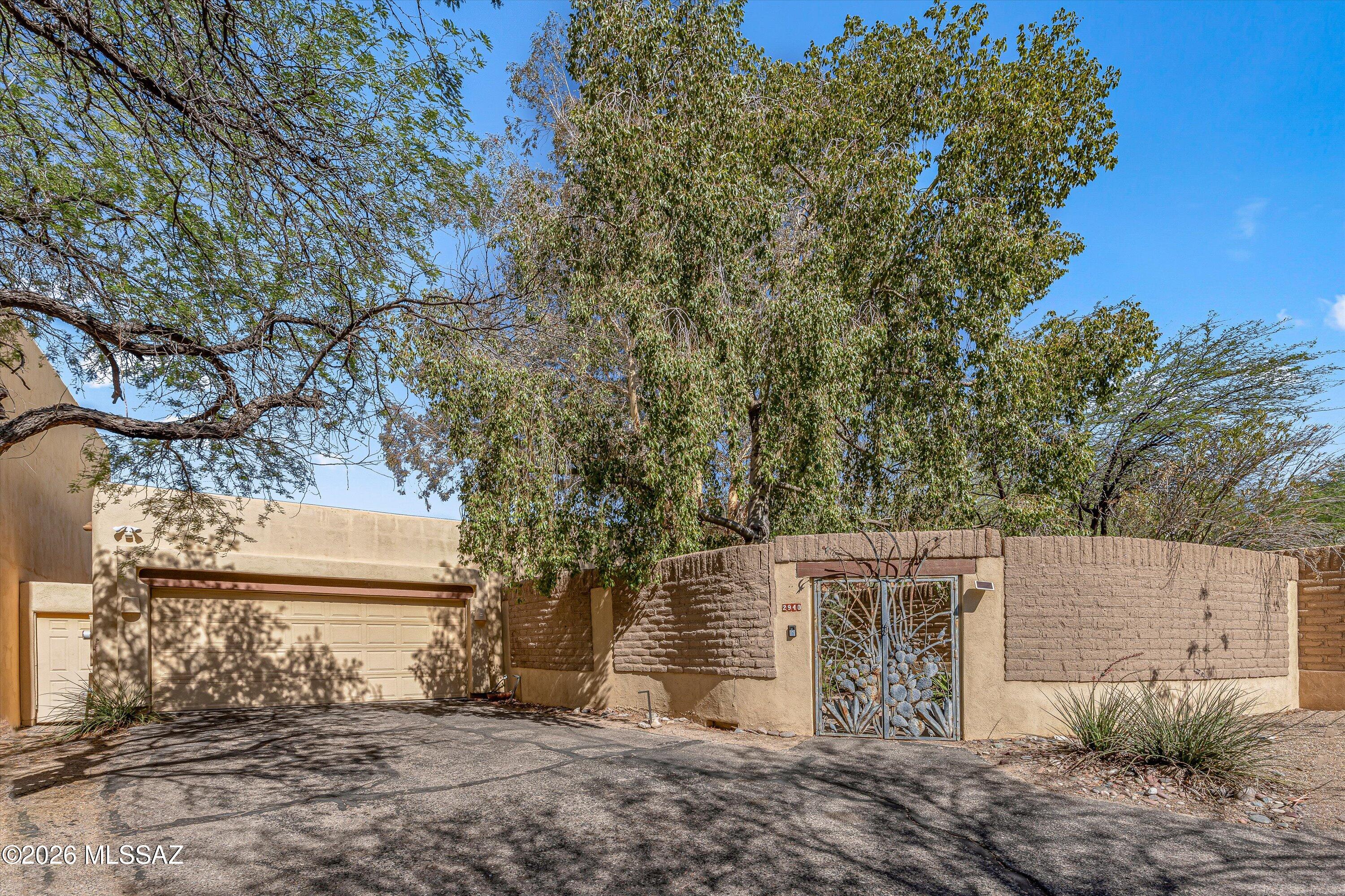 Rare opportunity & fix-up in Old Fort Lowell Estates. In the last 10 years, only 3 homes have gone on the market in this charming and peaceful enclave. Just beyond the 8ft adobe walls that surround the home, you will find verdant gardens, thriving shade and citrus trees, a pebble-tec pool and spa, a covered patio and so much more. With viga beams in the great room, a beehive fireplace, skylights, and bright and beautiful tile work in the bathrooms, this centrally located custom home is full of Tucson character. The home also features a 2 car garage and workshop. Walking distance to shopping and dining.