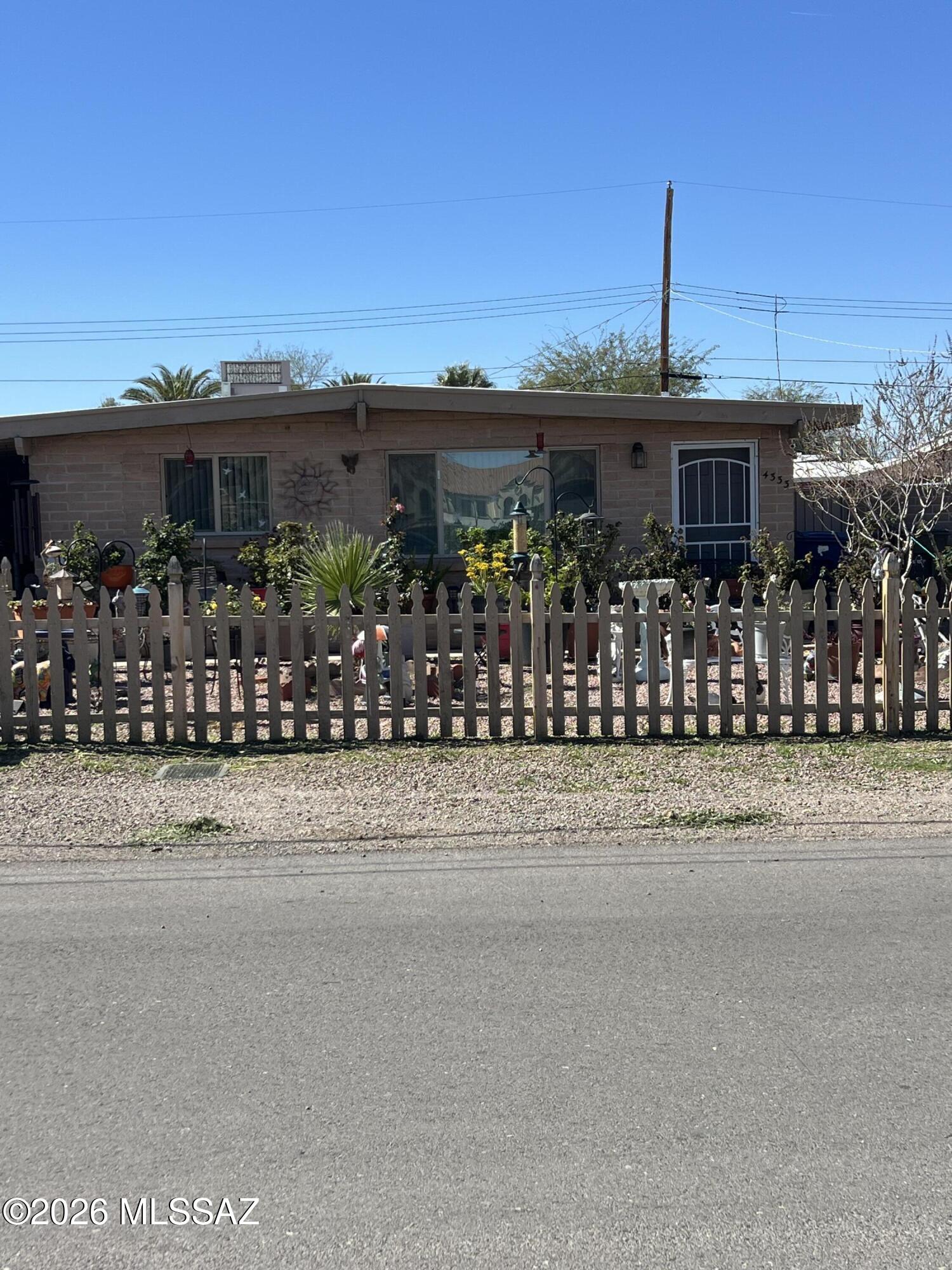 This lovely three-bedroom, two-bathroom house has a large backyard and no carpet. A modern open kitchen, large living space, double carport, modernized bathrooms, and tile floors! Shopping, transit service, and the Tucson Mall are all nearby!  The front yard's picket fence enhances the curb appeal. Gorgeous views of the mountains as well! Across the street from the family park in Limberlost!