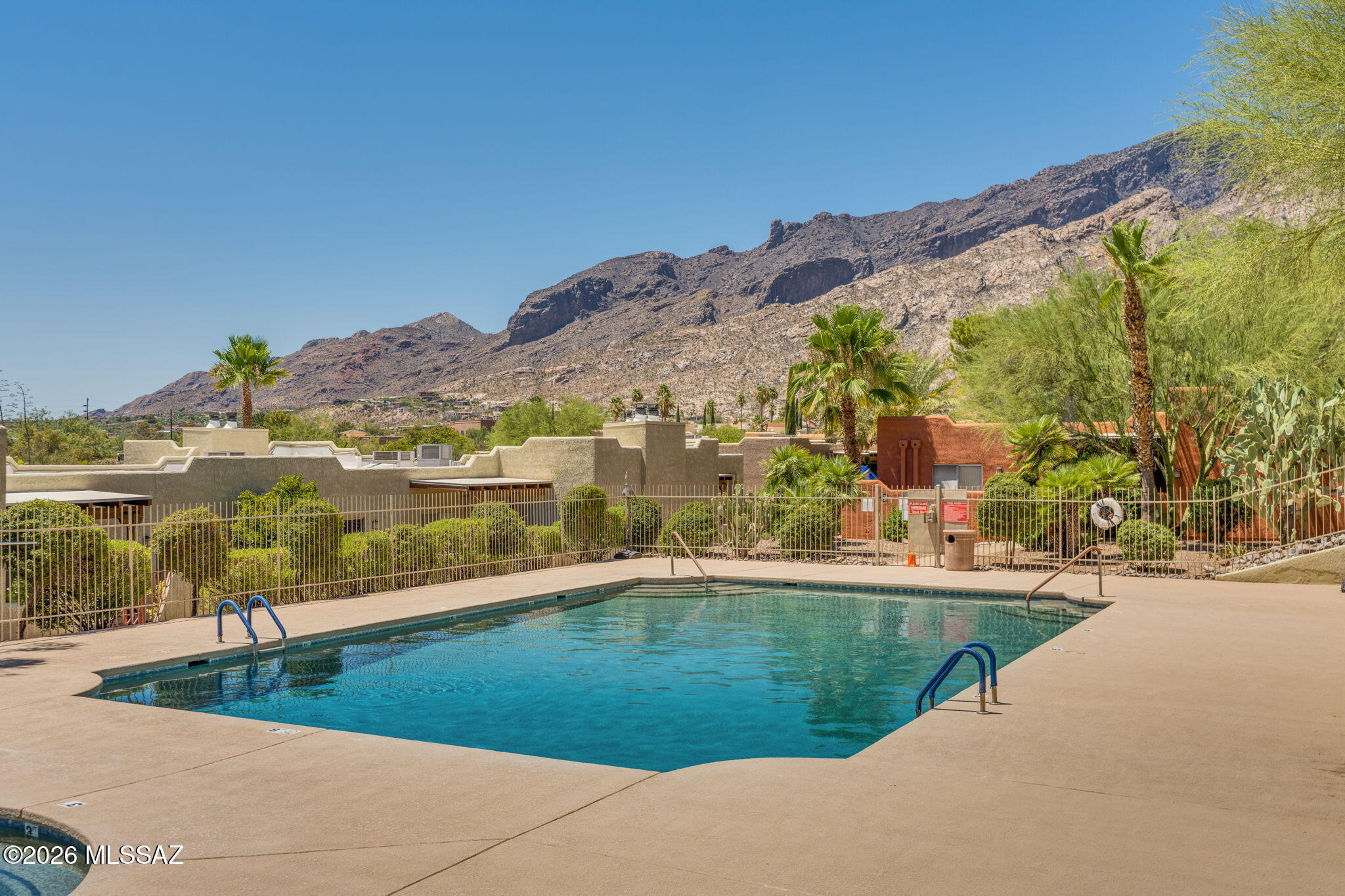 Ground floor with beautiful amenities. Welcome to this beautifully updated 2-bedroom, 2-bathroom condo in the highly sought-after ''Reflections in the Catalinas'' condo community. This spacious 1,258 sq ft single-level unit offers an open-concept great room with a cozy wood-burning fireplace, soaring  ceilings and a relaxing front courtyard for private tranquility. Enjoy breathtaking Catalina Mountain views from the manicured grounds and common areas. Rentals allowed
The modern kitchen features granite countertops, stainless steel appliances, and a convenient built-in desk/work area. Both bathrooms have been tastefully updated with tile countertops and fixtures. Additional highlights include dual pane windows, walk-in closets in both bedrooms, and a dedicated laundry room.