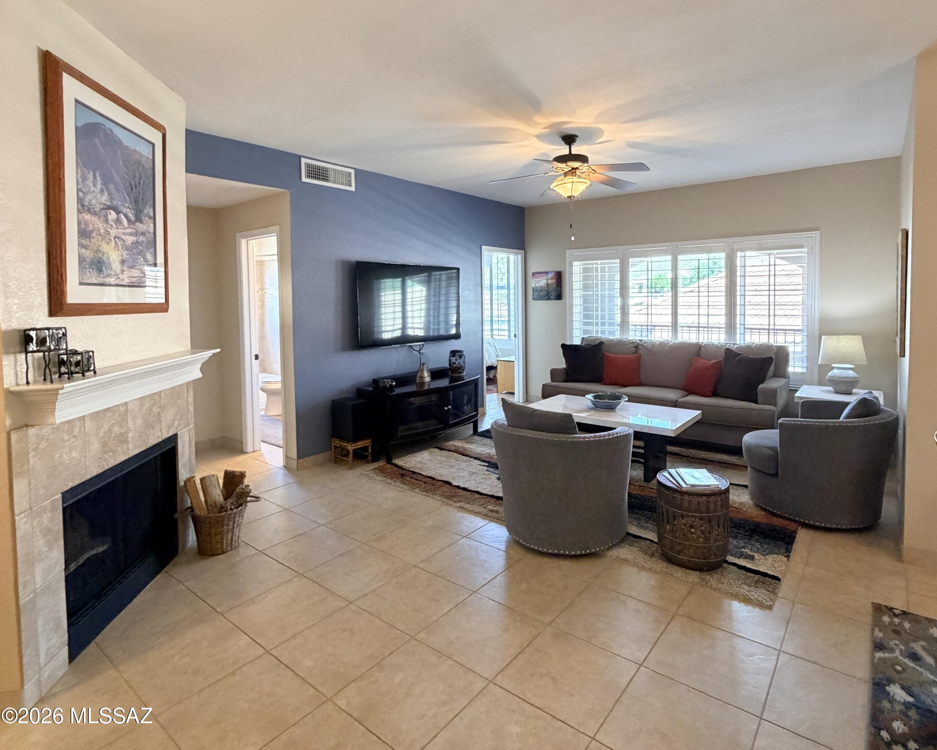 Resort style living w/o the maintenance. Popular open concept 3 bed/2-ba condo tucked at the base of picturesque Catalina mountains in the heart of Oro Valley. Panoramic mountain views from the main living areas, owner suite, office/2nd bedroom. . Newer Milgard window, tastefully upgraded w/wood shutters on all windows,& oversized tile throughout. Kitchen hosts  Stainless appliances, custom wood raised panel cabinets & granite counters adding distinctive appeal. Lrg. L-shaped patio is the perfect place to gaze at the mountains, relax or entertain. Spacious gr8 room plan w/fireplace. Owner suite w/separate bath retreat, walk-in closet & exec. height vanity. H20 heater-only 4 years old. HVAC replaced in 2019. Enjoy AZ outdoor living on the premium grounds w/pool, spa & state workout facility