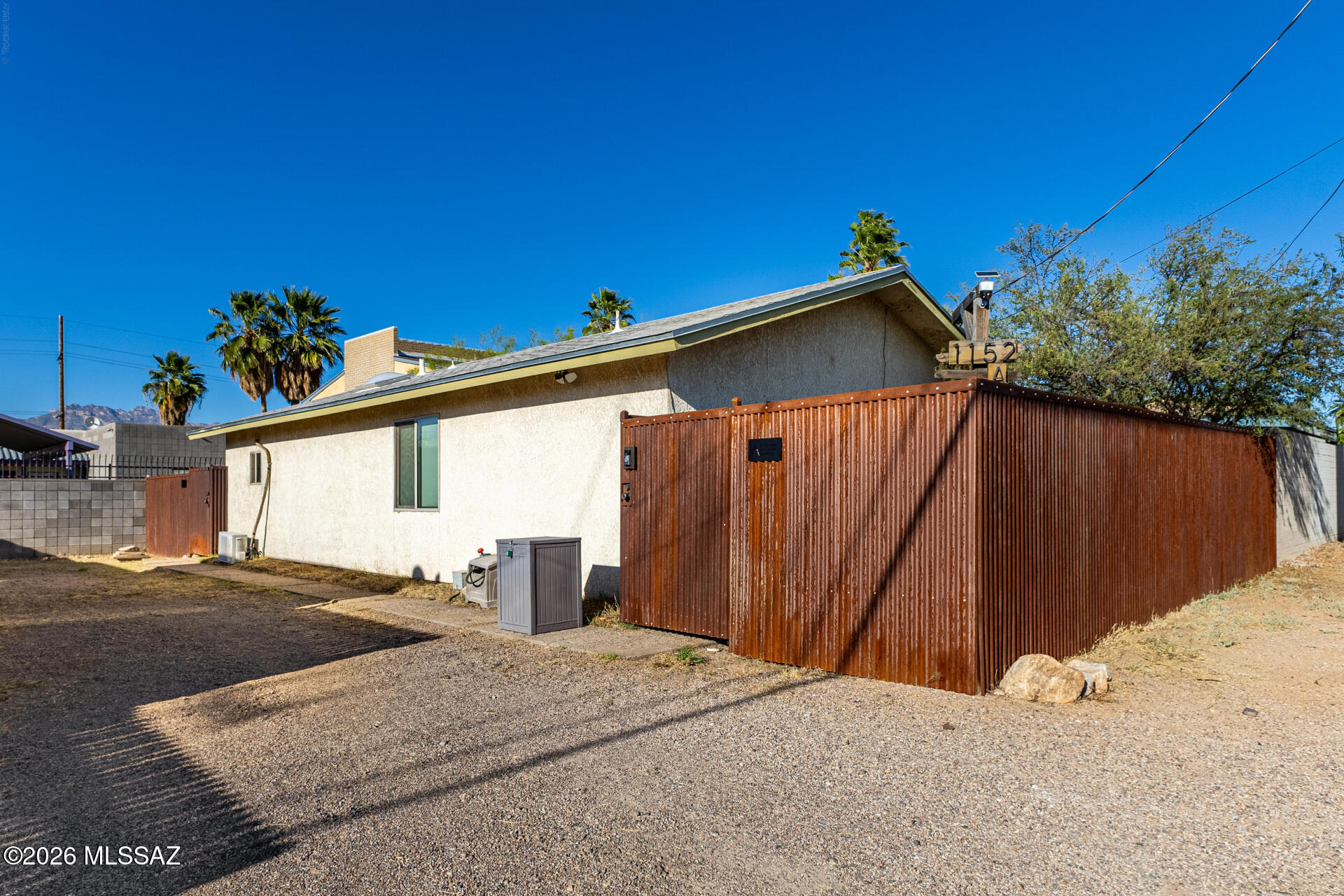 Rare corner lot with mountain views and incredible income potential! This property features two separate structures: a 2-bedroom main house and a rear duplex with mirrored units. The main house is fully fenced with a large front yard, covered porch, and side patio. Inside, enjoy a bright living/dining room with laminate flooring and recessed lighting. The galley kitchen features a stainless fridge and gas range, while sizable bedrooms offer great natural light. The secluded backyard with a covered patio is perfect for entertaining. The duplex units each feature Saltillo tile floors, a full kitchen, a living/dining area, and a bedroom with closet and bathroom. Live in the main house and rent the duplex -- a perfect house-hacking setup. Don't miss this versatile investment opportunity!