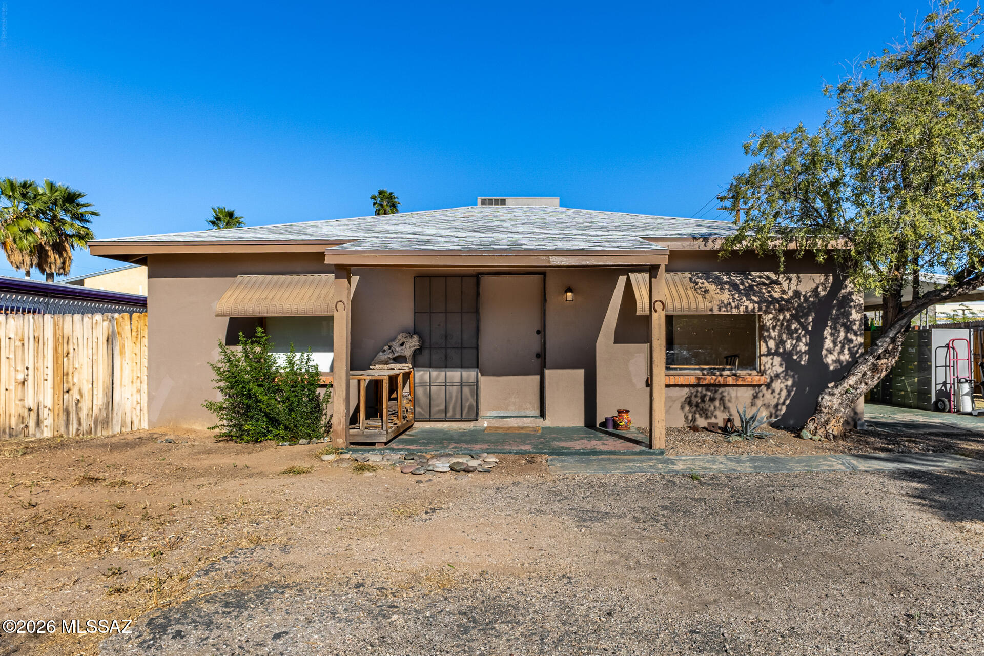 Rare corner lot with mountain views and incredible income potential! This property features two separate structures: a 2-bedroom main house and a rear duplex with mirrored units. The main house is fully fenced with a large front yard, covered porch, and side patio. Inside, enjoy a bright living/dining room with laminate flooring and recessed lighting. The galley kitchen features a stainless fridge and gas range, while sizable bedrooms offer great natural light. The secluded backyard with a covered patio is perfect for entertaining. The duplex units each feature Saltillo tile floors, a full kitchen, a living/dining area, and a bedroom with closet and bathroom. Live in the main house and rent the duplex -- a perfect house-hacking setup. Don't miss this versatile investment opportunity!