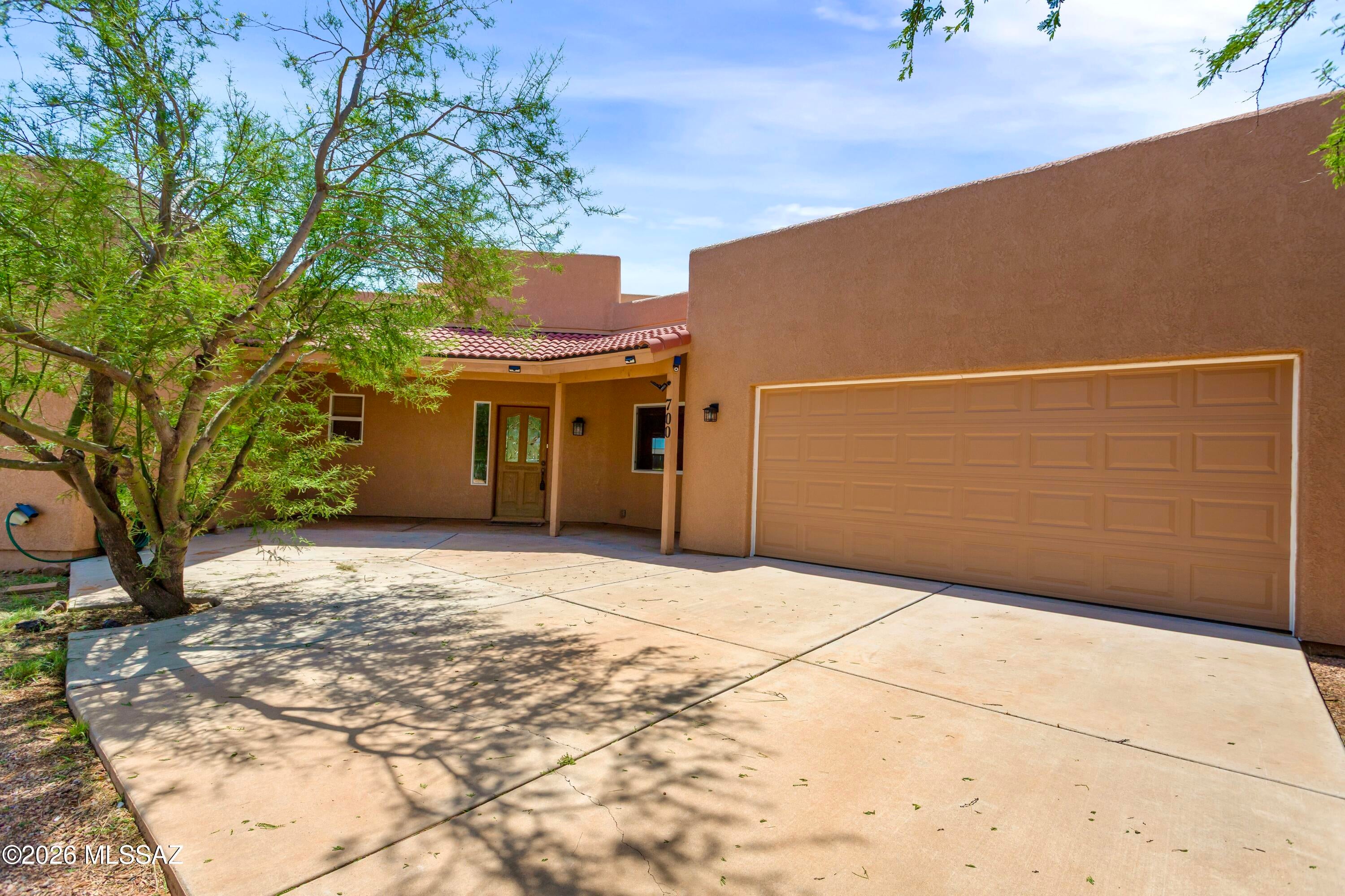 Santa Fe Style Meets Equestrian Living with Mountain Views! Welcome home to this charming 3-bedroom, 2-bath Santa Fe-style property offering comfort, character, and an incredible Arizona lifestyle. The spacious interior features tile flooring throughout, impressive 10-foot ceilings, and generously sized bedrooms--each with its own walk-in closet! Step outside to enjoy stunning mountain views from the custom pergola-covered patio, perfect for relaxing, entertaining, or enjoying beautiful Arizona sunsets. The fully fenced horse property includes a barn with stalls and tack rooms, along with RV hookups for added convenience. A 2-car garage provides additional parking and storage. With space for horses, an RV, hobbies, and outdoor enjoyment, this versatile property is ready to welcome you!