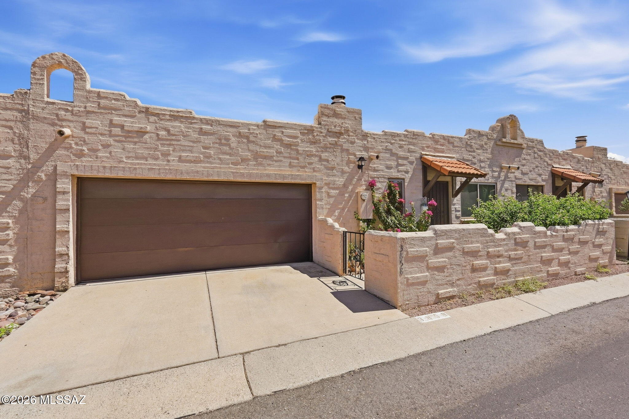 This 2 Bed/2 Bath southwestern-style townhome is nestled in a small, quiet development in a popular central Tucson neighborhood. It offers charm and convenience in a vibrant location close to the University of Arizona, the North Campbell shopping and dining corridor, St. Philip's Plaza, public transportation, and more! Boasting an updated kitchen and baths and newer HVAC system, this is a terrific location for first time buyers or those looking to downsize and be close to amazing Tucson amenities. Inside you will find an open floorplan with skylights and a corner fireplace. The flooring is ceramic tile and engineered wood floors (no carpet here). Primary bedroom has access to a private patio and small yard to relax in and enjoy. Attached 2-car garage with storage makes this a MUST SEE!