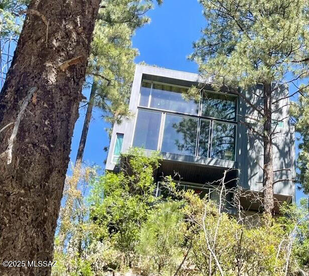 The Cubist — designed by award-winning architect Kevin B. Howard — takes Mt. Lemmon and Summerhaven real estate to the next level and beyond. This architectural masterpiece showcases uncompromising design, exceptional quality, and the finest finishes, appliances, and fixtures.
Perfectly positioned to capture spectacular Mt. Lemmon and lush forest views, this three-story modern ''Glass Treehouse'' redefines the standard for a summer retreat in Southern Arizona. Every detail reflects a commitment to luxury, innovation, and harmony with the natural surroundings. Located in the heart of Summerhaven, this remarkable property is easy to preview, with the exclusive opportunity to meet directly with the architect/builder to fully appreciate the vision and craftsmanship of this one-of-a-kind h