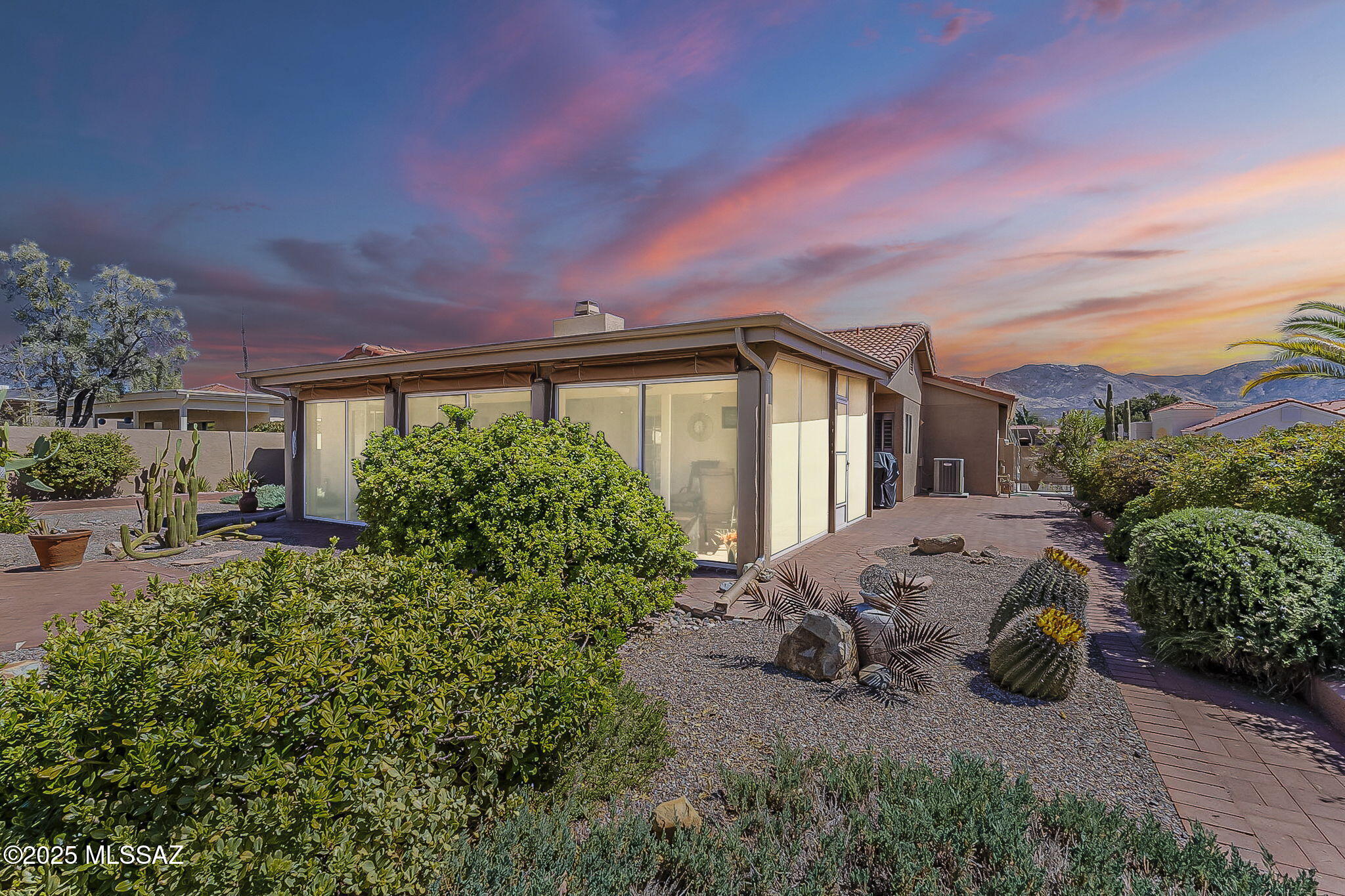 Beautifully maintained SaddleBrooke One SHAWNEE floor plan. Backyard w/beautiful paddle cacti over-sized Arizona room providing a private outdoor retreat with mtn views. New irrigation (2020) with WiFi-enabled Hydrawise timer (2024) for remote control. Inside, comfort and convenience with a smart Ecobee thermostat (2020) accessible remotely. No carpet - wood laminate & luxury vinyl. Guest room has ensuite bath. Exterior painted (2021). Cozy fireplace w/new gas log set (2024). Extended garage w/extra storage. This home combines modern technology, thoughtful landscaping, and classic charm - unpack and enjoy!
