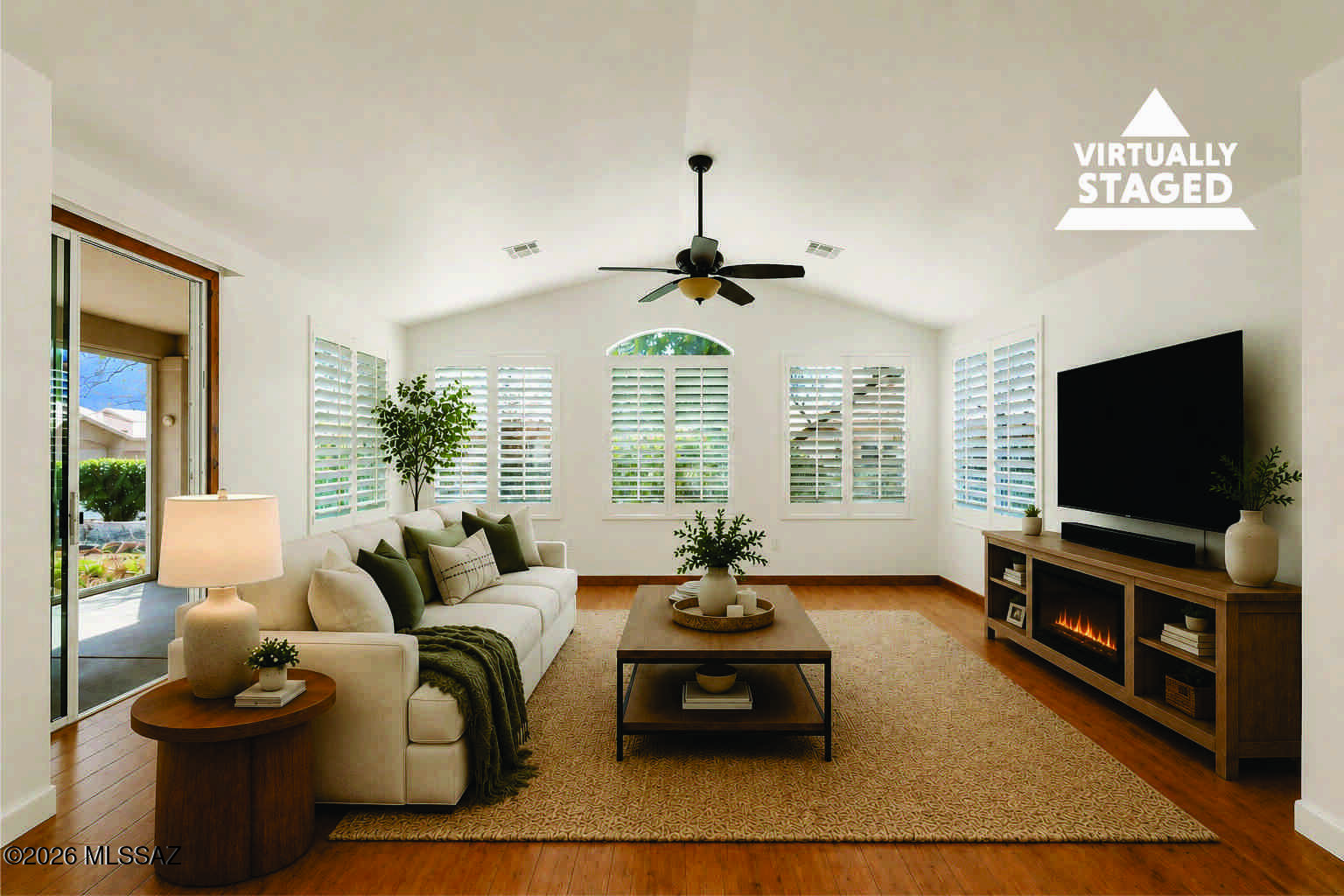 Impeccably maintained Riviera villa with Catalina Mountain views and an expansive screened Arizona Room. Privately tucked along a quiet walkway, this light-filled home features a desirable split floor plan and spacious great room with engineered wood floor (no carpet), plantation shutters, and elegant architectural arches connecting the living and dining areas. Sliding doors from the great room and primary suite open to one of the largest screened Arizona Rooms in the villas, creating inviting indoor-outdoor living with a pet-safe patio and mountain views. The vaulted kitchen offers quartz counters, warm wood cabinetry, and a center island. The primary suite includes dual quartz vanities and two closets, while a versatile guest bedroom sits near a hall bath with therapeutic tub. Villas HO covers exterior maintenance including landscaping, pest control, exterior paint, and roof maintenance and replacement, delivering true low-maintenance resort living.Located in SaddleBrooke, an award-winning active adult community offering golf, pickleball, pools, dining, and vibrant social clubs.