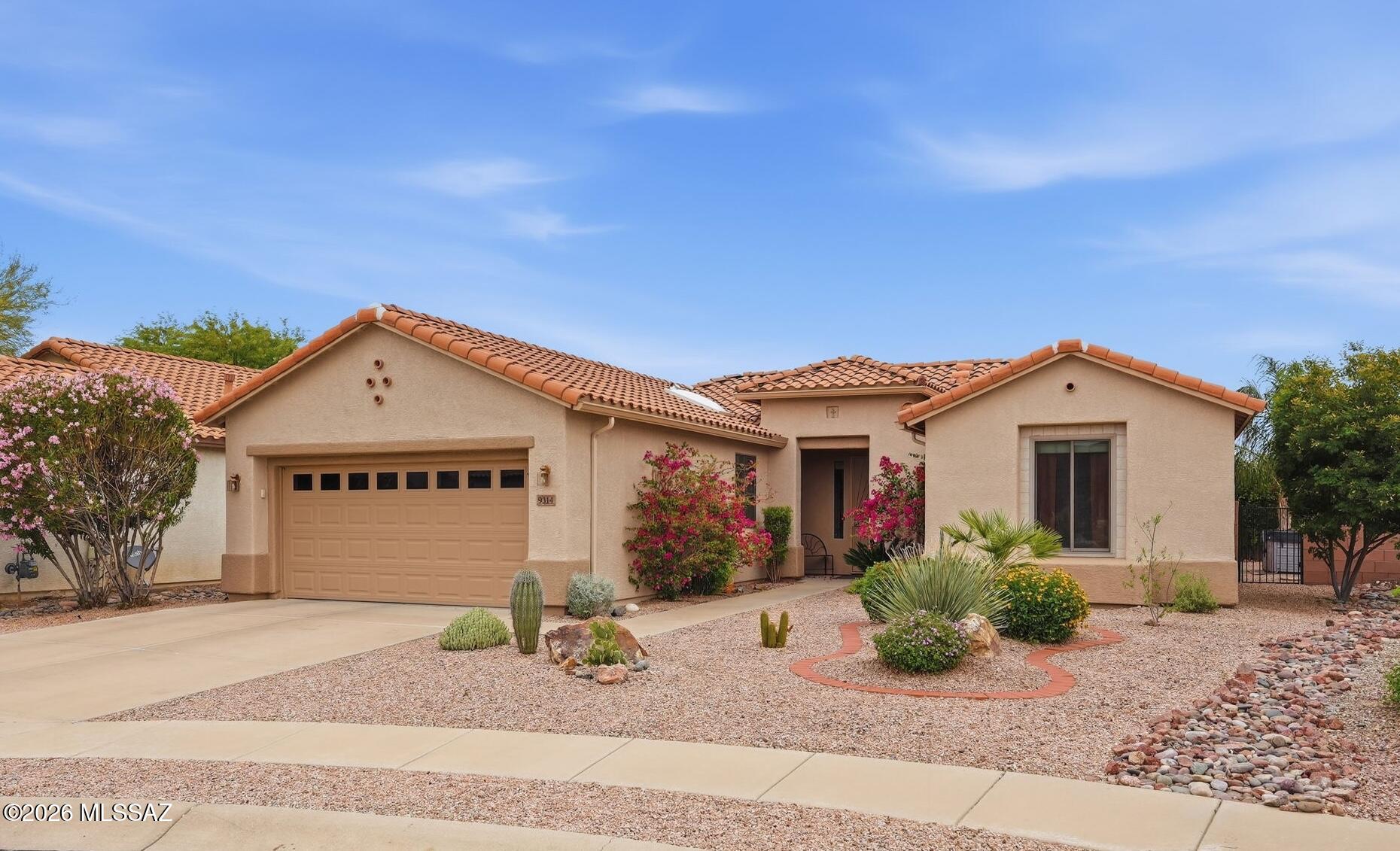 Wrap yourself in the warm glow of desert hues and lush, thoughtfully designed landscaping in this beautifully appointed two-bedroom, two-bath home, complete with a versatile den and dedicated office. The inviting kitchen is both stylish and functional, featuring stainless steel appliances, quartz countertops, and convenient pull-out cabinet organizers. Throughout the main living areas, low-maintenance ceramic tile and vinyl plank flooring offer durability with a refined finish. The bright, well-lit office provides the perfect space for hobbies or remote work, while the spacious den offers flexibility as a potential third bedroom with the addition of a Murphy bed or sleeper sofa. Step outside to your private backyard oasis, where you can unwind in the jetted hot tub while taking in serene views of the Tucson Mountains. Enjoy gardening among a variety of established plants and shrubs, or relax beneath the shade of the east-facing patio--ideal for peaceful mornings and cool afternoons. Beyond your doorstep, a vibrant and active lifestyle awaits. Located within the welcoming Sunflower active adult community, residents enjoy a wide array of amenities and social opportunities--from pickleball and scenic desert walking trails to mahjong, community dinners, and more. This is more than a home--it's a lifestyle. Come experience it for yourself.