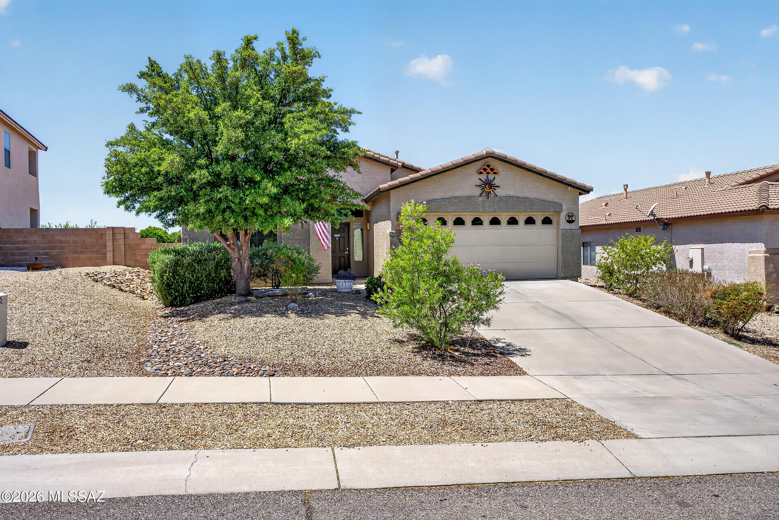 Welcome to this beautifully maintained 3bd/2ba in the highly acclaimed Vail School District! Sited on a premium lot, this home offers exceptional privacy-backing to common area with no immediate rear neighbors. Enjoy energy savings with OWNED SOLAR, a 2021 HVAC (17 SEER2) & extra attic insulation! Inside, you'll find a gourmet kitchen w/granite counters, large island w/breakfast bar, SS appliances & spacious great room w/gas fireplace. Owner's suite features large walk-in closet, soaking tub & separate shower. Additional highlights include oversized diagonal tile, room-darkening window coverings & an impressive finished garage w/epoxy, 4-ft extension, cabinets, workbench & storage. Private backyard oasis w/full length covered patio, water feature & stunning landscaping. SEE UPGRADE SHEET!!