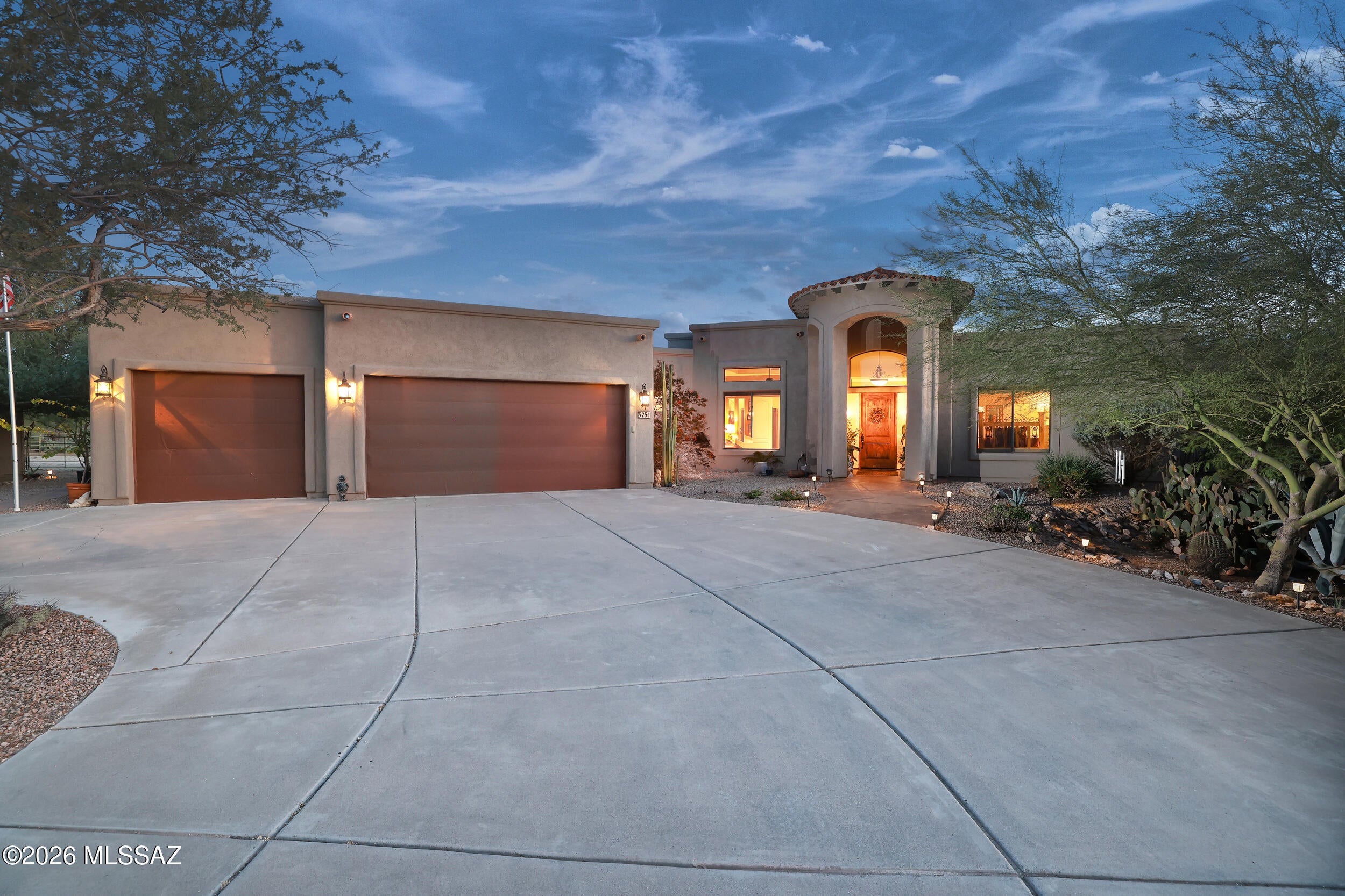 Very private & resort-like, this custom-built Northwest Tucson residence captures the essence of elegant desert living. Nestled on 2 acres surrounded by lush native flora & fruit trees, this exceptional horse property showcases breathtaking 360 views of the Catalina Pusch Ridge, Tortolita, & Tucson Mountains with sparkling city lights to the South & magnificent sunrises & sunsets painting the desert sky in every direction. The terraced wraparound patio, complete with remote-controlled electric shades & eyebrow extensions, provides an idyllic setting for a morning coffee or evening gatherings. Inside, the spacious 4-bedroom, 3-bath split-bedroom design features soaring 12-foot ceilings, walls of windows framing stunning mountain views, & a grand sense of space and light throughout. The gourmet kitchen is a showpiece perfect for entertaining with an induction cooktop, Bertazzoni telescopic hood, granite countertops, and a generous breakfast bar. Elegant granite executive-height vanities and custom Knotty Alder cabinetry flow throughout, highlighted by a striking 8-foot solid entry door. The open great room centers around a warm wood-burning fireplace and newer French doors provide access to outdoor living spaces. A private guest suite with its own wing and entrance offers exceptional flexibility for multi-generational living or extended guests. Zoned for horses and complete with horse facilities. This Electric Energy Efficient home has an owned Solar System with net metering. Ideally located near The Loop multi-use path, Catalina State Park, The Gallery Golf Club, The Highlands Golf Club, and Tortolita Mountain Park, & Preserve, this property offers an unparalleled blend of serenity, privacy, and proximity to some of Tucson's most stunning recreational destinations. Only minutes from I-10, Shopping and Restaurants. (Be sure to view the video at the tab)