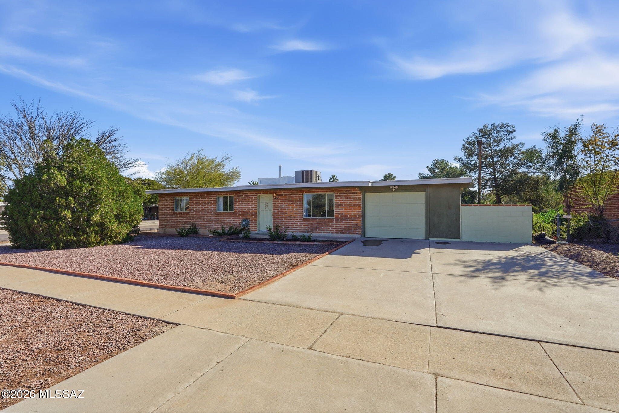 Fantastic Mid-Century Modern Home on a corner lot. Stainless steel appliances. Spacious open floor plan, neutral tile floors, lots of natural light & ceiling fans. Retro kitchen w/updates! Breakfast bar, double sink, tile backsplash & plenty of wood cabinets. Formal dining area is perfect for entertaining. Plush new carpet in 2 bedrooms, ample closets & fun tile bathrooms. Garage has a storage/workshop closet. Large backyard features a covered patio & outdoor laundry hook-up, storage shed & room for a pool & garden! NO HOA! Conveniently located near Shopping, Dining & more.
