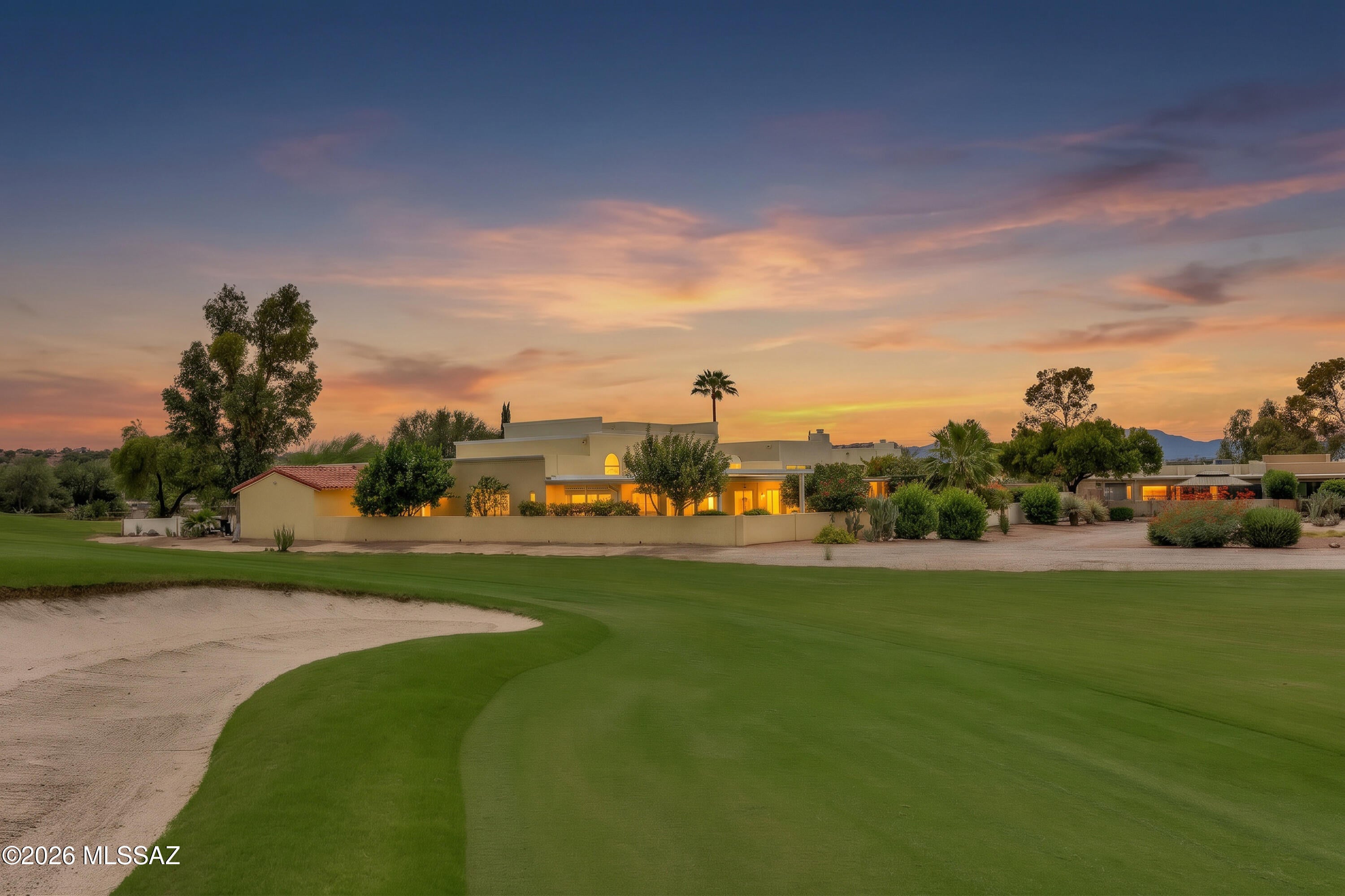 Seller is offering up to $5000 towards interest rate buy down with an acceptable offer.  Discover refined golf-course living on the 14th green of Omni Tucson National Golf Course. This exceptional 2,615 sq ft residence is privately positioned to capture sweeping mountain and fairway views, with no homes directly across the street or behind and only one neighboring residence. Inside, soaring cathedral ceilings, sophisticated finishes, and abundant natural light create an inviting sense of scale. The beautifully enhanced kitchen features new tile flooring and backsplash, refinished cabinetry, a new range/oven, and a spacious walk-in pantry. The luxurious primary suite offers two walk-in closets, a versatile extended sitting area with patio access, and a spa-inspired bath with a soaking tub, walk-in shower, heated travertine flooring, and generous storage. Entertain in style in the impressive pub, complete with two wine refrigerators, dual TVs, fireplace, custom bar, sink, and spectacular views. The pub and primary suite open to a serene flagstone patio with a remote-controlled pergola, built-in outlets, citrus trees, and beautifully landscaped grounds. A rare 3-car garage with extensive storage and workspace adds exceptional functionality. Recent upgrades include HVAC, water heater, irrigation, roof maintenance, lighting, and more creating a truly special retreat where luxury, privacy, and the beauty of Tucson come together.