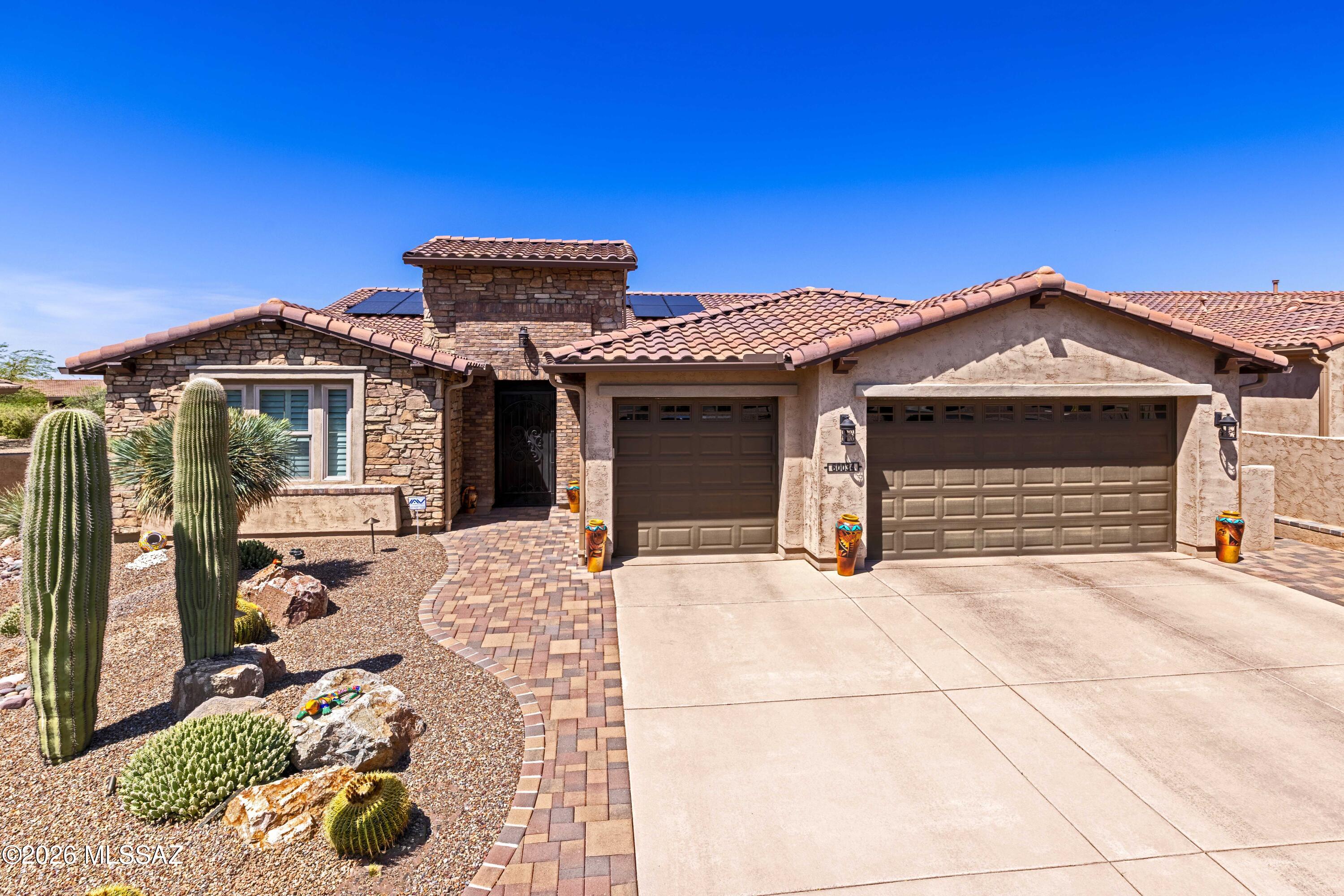 Extended primary suite & 3-car garage on a premium arroyo lot! SE-facing Vienta with sunset & mountain views, beautifully landscaped & fully fenced yard -- snake fence for peace of mind. Paver patio with wall-mounted fireplace & electric shades. Inside: tray ceilings, tall doors, custom glass front & iron security doors, plantation shutters & top-down/top-up blinds, LVP & carpet, ceiling speakers throughout. Chef's kitchen w/2-yr-old high-end induction appliances, reverse osmosis & under-cabinet lighting. Whole-house air purifier, owned water softener, owned solar, security system & keyless entry. Epoxy garage floor w/built-in cabinets. Meticulously maintained & move-in ready -- enjoy SaddleBrooke Ranch resort living!