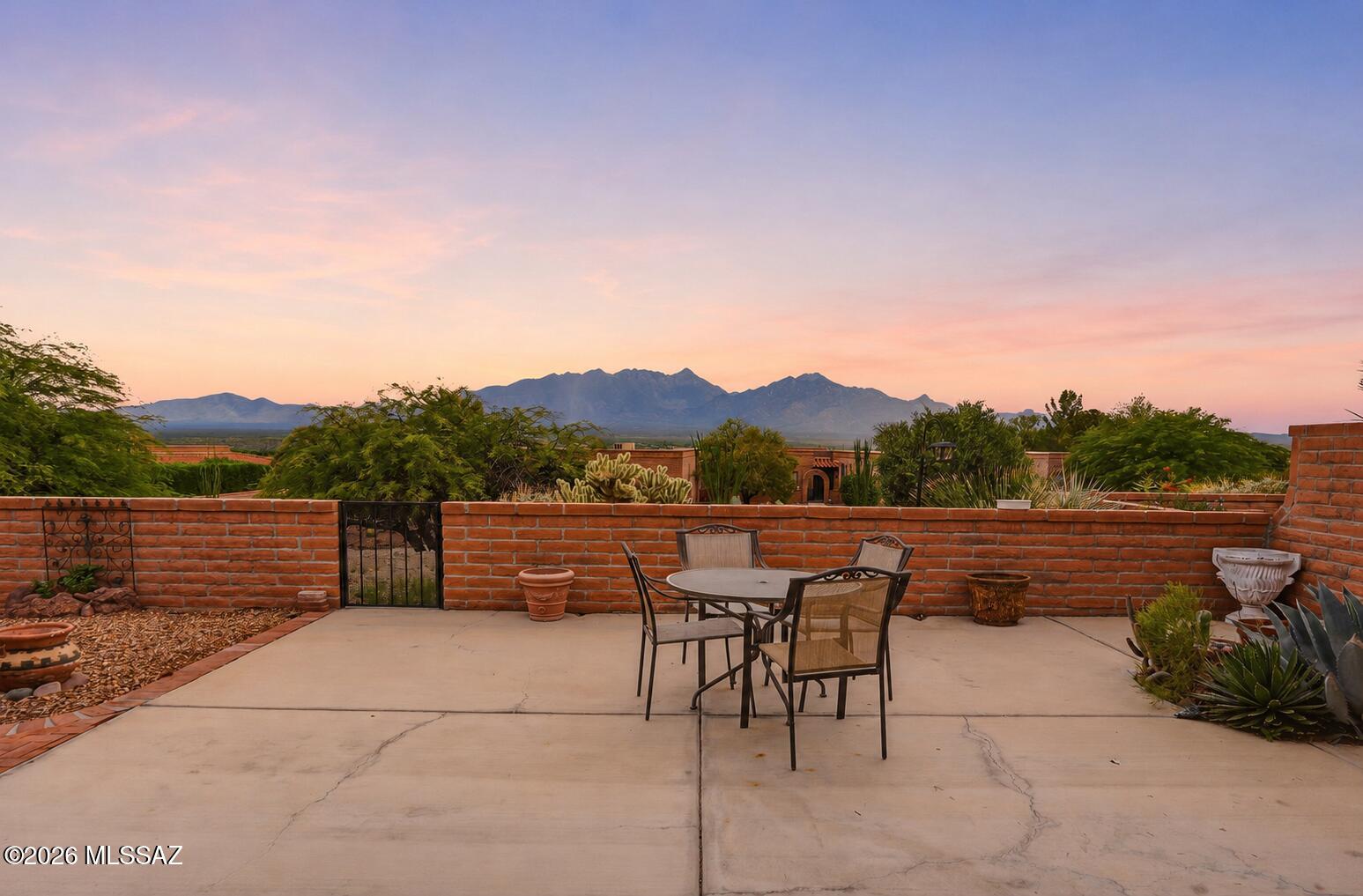 Experience Glorious Mountain Views from this well-maintained 1,740 sq. ft. slump-block home situated on a desirable corner hillside lot in Canoa Ridge. The split-bedroom floor plan offers 2 bedrooms, a den, 2 bathrooms, and spacious living and dining areas with a cozy gas fireplace. The kitchen features granite countertops, a subway tile backsplash, newer slate appliances, a double oven with convection options, and a comfortable breakfast area. Additional highlights include fresh interior paint, no carpet, a 2-year-old gas water heater, water softener, and a 2-car garage. Enjoy Arizona outdoor living from three covered patios showcasing beautiful views of the Santa Rita and Catalina Mountains. No pets or smoking in the home.