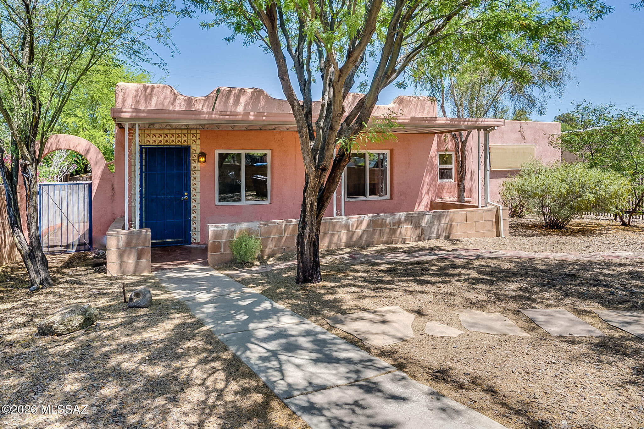 Midtown 3 bed/2 bath home with 2 private entrances, a large fenced yard, covered patio, courtyards, next to Randolph Park, El Con and restaurants. This home has a large open kitchen with a separate sitting area next to a bay window overlooking the fenced backyard, which has a tandoori oven, fruit trees and native vegetation. This home has good light, color, warmth and old adobe/Saltillo-tile charm. The largest bedroom is 20x14 ft and has an adjoining bathroom with a private jacuzzi bath and walk-in closet. This bedroom suite has a backdoor entrance. The middle bedroom is sizable and has a walk-through large closet, room for a desk, and its own entrance to a side-yard. This room has a shared bathroom with the smallest bedroom. Between the smaller, adobe, bedroom and the middle-sized bedroom ... is a separate office or workspace. Adjoining these is a small bathroom (with shower/sink/toilet). Note that the two larger bedrooms have separate outdoor entrances. The house has these appliances: refrigerator, dishwasher, disposal, microwave, gas stove, and ceiling fans (with a solar water heater). There are two AC units because the home layout has bedrooms far apart. This home has a washer and dryer dedicated to the tenants of this main house that sits in a dedicated closet in the East-side walkway. There are bricked-fenced areas in the front yard, West side courtyard (with a water tank), and the East courtyard/walkway. Only the backyard is separated from the casita in the backyard with a chain link fence, but the property is mainly bricked fencing. The backyard overlooks another yard with an occupied guest house.