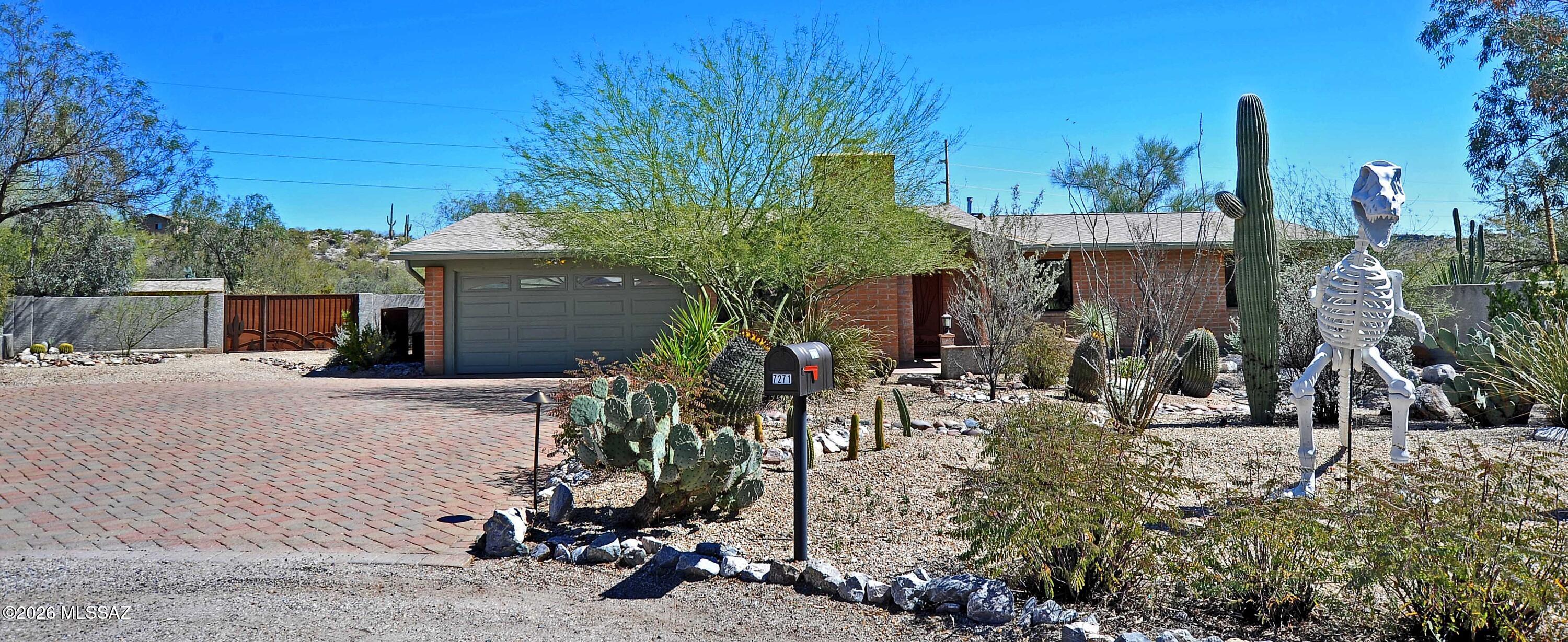 Tucked away on a quiet cul-de-sac, this beautifully maintained home offers privacy, stunning Catalina Mountain and Sabino Canyon views, and extraordinary desert gardens inspired by the Tucson Botanical Gardens, Tohono Chul, and the Arizona-Sonora Desert Museum. Located in an incredible Catalina Foothills setting near upscale shopping, premier resorts, golf courses, hiking and biking trails, and popular restaurants, and within the highly sought-after award-winning District 16 school district.
Situated on one of the largest lots in the subdivision with nearly 30,000 sq. ft., the property offers exceptional outdoor living. Winding pathways lead through vibrant desert landscaping featuring flowering cacti, agave, yucca, mesquite, palo verde, acacia, and other native plants, creating a peaceful backyard retreat filled with songbirds, hummingbirds, hawks, and other desert wildlife.
The recently constructed brick paver patio provides an ideal setting for entertaining or relaxing while enjoying mountain views and Arizona's incredible stargazing. Multiple shaded seating areas, fountains, and garden viewing spots create a tranquil outdoor sanctuary. The backyard is fully enclosed with a masonry wall, providing both privacy and space for pets to roam and a double decorative gate for easy access. 
The brick paver driveway accommodates parking for 5-6 vehicles with additional gravel parking area available for guests. Decorative brass LED driveway lighting on timers adds charm and convenience, while custom-designed security screen doors and a decorative backyard gate feature artistic metalwork inspired by the surrounding desert landscape.
 The kitchen is highlighted by Brazilian Mascarello granite countertops, undermount sink, gas range with both gas and electric connections, overhead and under-cabinet lighting, French door refrigerator with water/ice dispenser, built in microwave, dishwasher and a gas range.
The primary bedroom includes a dedicated mini-split heating and cooling system for enhanced comfort and efficiency, French doors to the brick paver patio, a jacuzzi tub with multiple jets, walk in shower with glass door and stone countertops. 
 The garage features large LED panel lighting and its own mini-split system, allowing for comfortable year-round use for hobbies, storage, or workspace or an easy addition for extra sq. footage. 
Major recent improvements include a new roof and exterior paint (2024), new HVAC system (2021), upgraded electrical breaker panel (2025), heat-rejecting window film, gutters and downspouts, and numerous additional upgrades throughout the home and property.
Additional upgrades include:  recessed dimmable LED, lighting, ceiling fans throughout, and numerous electrical outlets designed for modern living, gutter system, and a fireplace. 
This unique Catalina Foothills property combines thoughtful upgrades, artistic desert landscaping, and exceptional outdoor living to create a peaceful Tucson retreat.