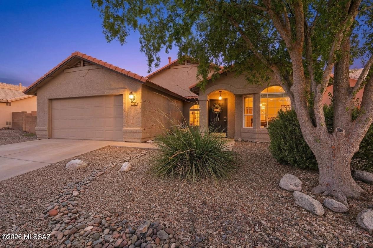 Amazing opportunity for updated 1,955 SqFt 4 bed/2 full bath modern contemporary home with refreshing pool, attached 2 car 454 SqFt garage, located in desirable Rita Ranch community in vaunted Vail School district. Built in 1998 by the original owners, pride of ownership shines! Single story on .16 acre elevated R-2 lot, N/S orientation, concrete tile roof, spacious concrete driveway, concrete sidewalks, on and off street parking, low maintenance landscaped front and backyard, located walking distance from Purple Heart Park with skate park, community pool, covered playgrounds, baseball fields, full basketball court and dog park. 
Inside enjoy soaring vaulted painted ceilings (no popcorn), designer paint, energy efficient dual pane windows, designer window blinds, window solar screens screens, luxury tile plank flooring w/carpet in bedrooms, no polybutylene plumbing, wired for alarm, Smart panel, gas HVAC, digital thermostat, crisp white 6 panel internal doors, modern lighting, illuminated ceiling fans, family room w/formal dining area, internal laundry room with all in one Smart GE washer/dryer included. Remodeled modern open kitchen with Corian countertops, large island with bar seating, upgraded kitchen cabinets, double oven gas stove, black appliance package, built-in microwave, double sink under garden window, adjacent to eat in dining and spacious living room with fireplace. Spacious guest bedrooms, updated full guest bathroom with shower/tub, primary bedroom with ensuite bathroom with updated modern dual sink vanity, shower/tub and walk in closet.
Entertainers dream backyard with extended upgraded finished covered patio with all purpose deck flooring and wired for surround sound, always green artificial grass, flower gardens, fenced dog run, sparkling duel drain pool with variable speed pool pump, cartridge filter, metal pool fencing, pool cool decking, surrounded by privacy block walls. Affordable $54 monthly HOA dues. The property sits close to great outdoor infrastructure, including the scenic Fantasy Island Mountain Bike Park, Purple Heart Park, and access points to the Chuck Huckleberry Loop trail system. Minutes away from groceries, restaurants, shopping, Raytheon, Target warehouse, Amazon, Davis-Monthan Air Force Base and I-10 access. This move in ready home is available for new owners to enjoy, call to make your appointment to view today!