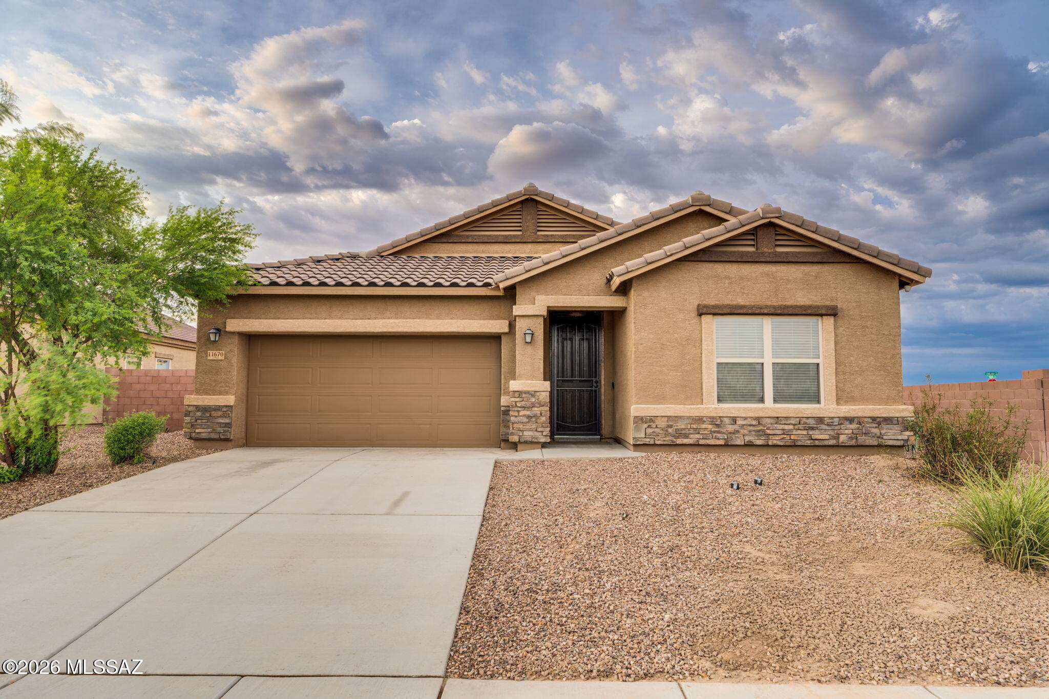Welcome home to this beautifully upgraded 4-bedroom, 3-bathroom home with a versatile bonus room, located in Gladden Farms. Ideally situated with easy access to I-10, this community offers parks, a skate park, splash pad, and an ever-growing selection of shopping, dining, and everyday conveniences. Inside, you'll find an open, functional floor plan featuring tile flooring throughout all main living areas, with carpet only in the bedrooms for added comfort. The home is enhanced with upgraded lighting and ceiling fans throughout, creating a modern and inviting atmosphere. The spacious kitchen and living areas flow seamlessly to the finished backyard, where extended pavers and a covered ramada provide the perfect space for relaxing or entertaining. Situated on a desirable corner lot with no rear neighbors, you'll enjoy added privacy and outdoor living. Additional highlights include a 3-car tandem garage, a tankless water heater, and a fully owned solar system, offering energy efficiency and long-term savings. This move-in-ready home combines modern upgrades, exceptional outdoor living, and an unbeatable location in one of the area's most desirable communities. Don't miss the opportunity to make it yours!