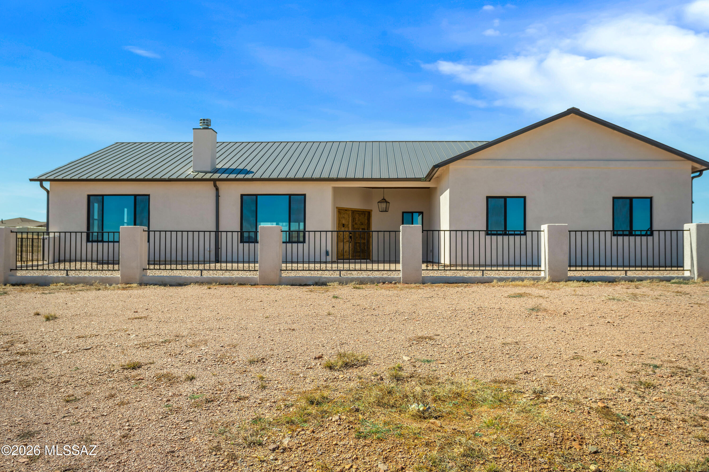 Attention to detail makes this Beautifull Custom-built 2000+sq. ft. home a must have. On a premium high knoll 4.13-acre lot enjoy amazing views of the Mustang and Santa Rita Mt. ranges. Star lite night skies from all directions. Inviting front courtyard with covered entry.  Wood tile floors throughout. Large great room, Living area complete with corner wood/gas fireplace. Kitchen perfectly done w/ high-end finishes. Alderwood cabinets, black stainless steel appliances Quart's counter tops island/breakfast bar. Double door pantry cabinet. Primary suit with large picture windows allowing for natural sun light. Onset bathroom, his and her vanity tile surround shower. 2 additional guest rooms. Located in the Santa Cruz Wine country. Where the Deer and antelope roam. No HOA you are in wine country.