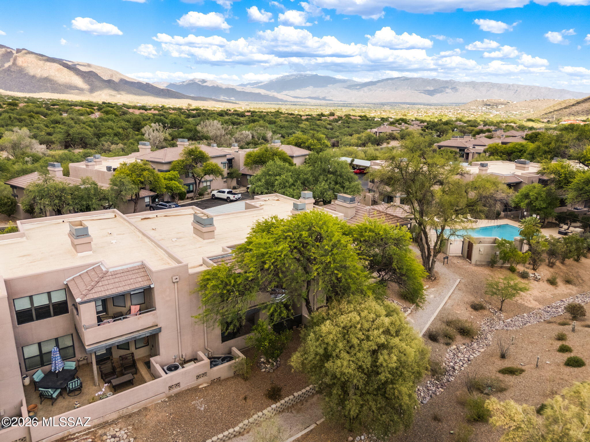 Welcome to your beautifully updated ground-floor retreat in The Greens at Ventana Canyon. This wonderful 2-bedroom, 2-bath condo features newer flooring, appliances, and stylish furnishings, creating the perfect modern desert getaway.
The spacious back patio includes an extended outdoor dining area with seating for four, ideal for enjoying Tucson's beautiful weather year-round.
Inside, the open living and dining areas provide welcoming spaces to relax and unwind. Two outdoor patio areas -- one covered for shade and one open with a patio umbrella -- offer the perfect setting for morning coffee or evening sunsets.