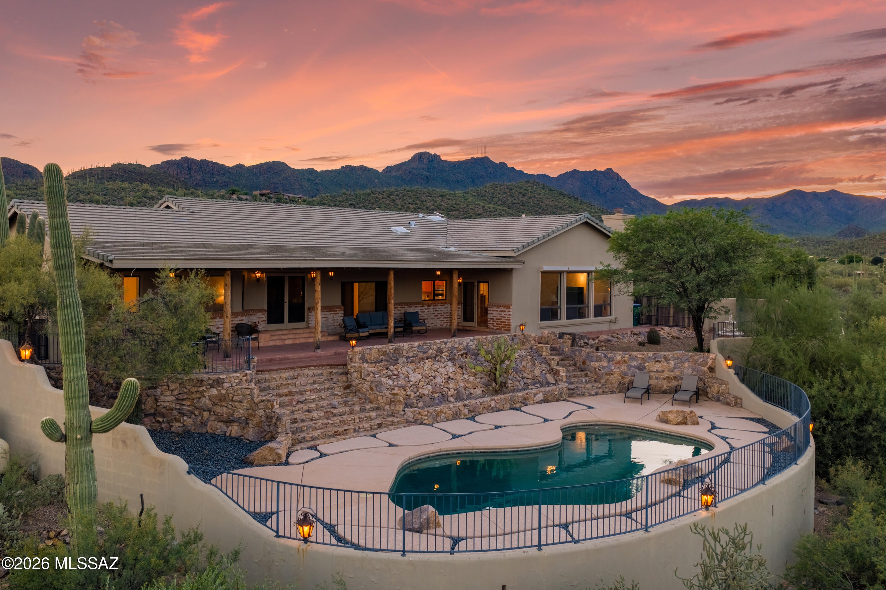 Experience the beauty of the Sonoran Desert from this exceptional 3.31-acre property with sweeping mountain, city and sunset views. This 2,879 sq ft, 3BR/2.5BA Southwestern-style home features a spacious split-bedroom floor plan and abundant natural light. The inviting family room showcases a dramatic vaulted wood ceiling, gas beehive fireplace and large view windows framing the desert landscape. Enjoy resort-style outdoor living with a Pebble Tec pool and expansive covered patio. Recent improvements include two high-efficiency HVAC systems, dual Rinnai tankless water heaters, 200-amp electrical panel and KitchenAid appliances. Oversized 2-car garage with workshop, 1/2 bath and no HOA complete this special Tucson retreat.