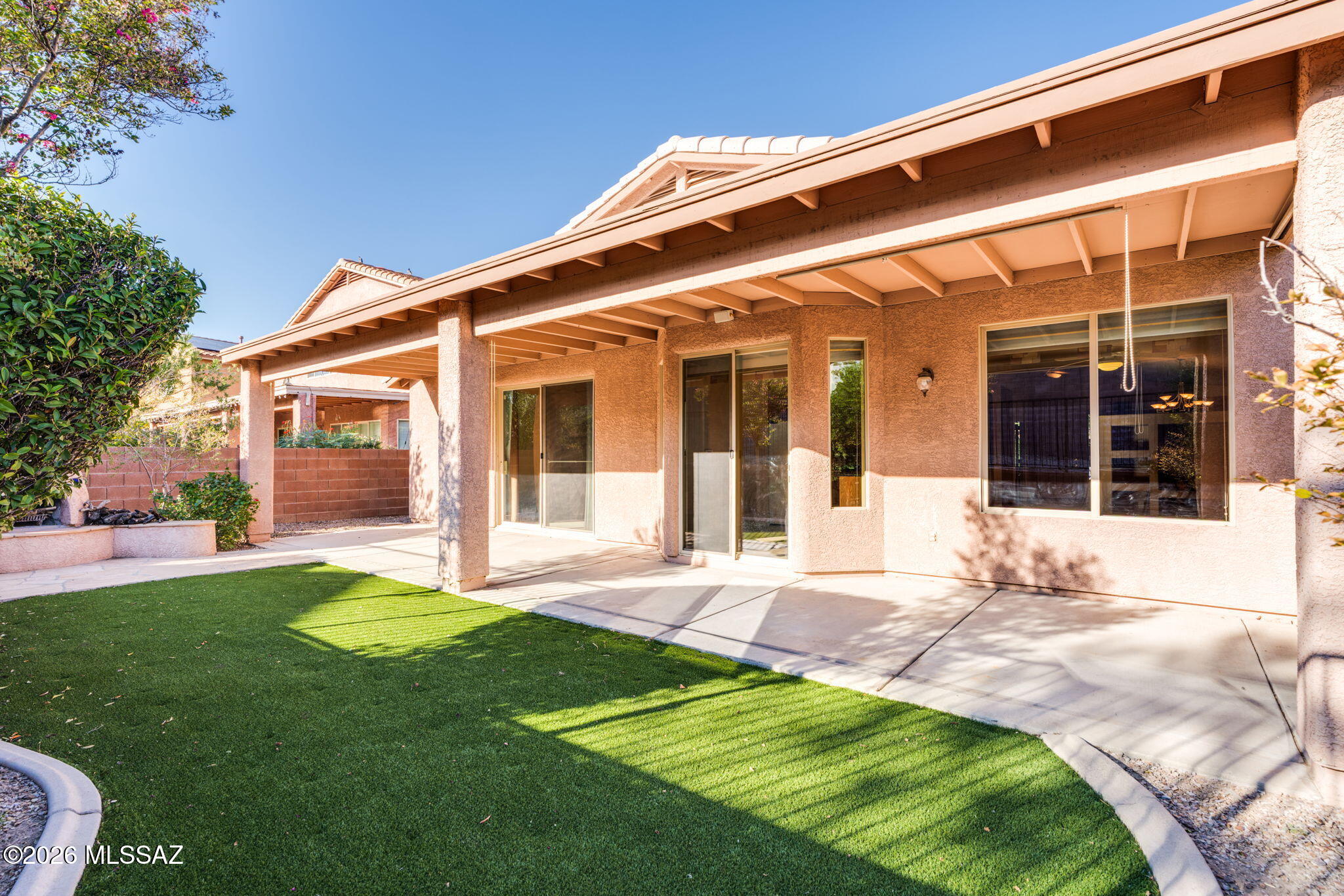 Former Monterey model home in the desirable gated community of Sweetwater Reserve! This beautifully maintained 3-bedroom home plus den features premium upgrades, high-end laminate flooring, custom window treatments, designer wallpaper and upgraded interior paint. Vaulted ceilings create an airy, spacious feel, while the primary suite offers a large walk-in closet. Enjoy the beautifully landscaped backyard with low-maintenance artificial turf and a charming fireplace--perfect for relaxing or entertaining. Newer water heater, professionally cleaned carpets, and washer and dryer included. As a resident of this quiet, well-kept community you'll also enjoy a community pool and spa, a neighborhood playground and scenic walking paths.