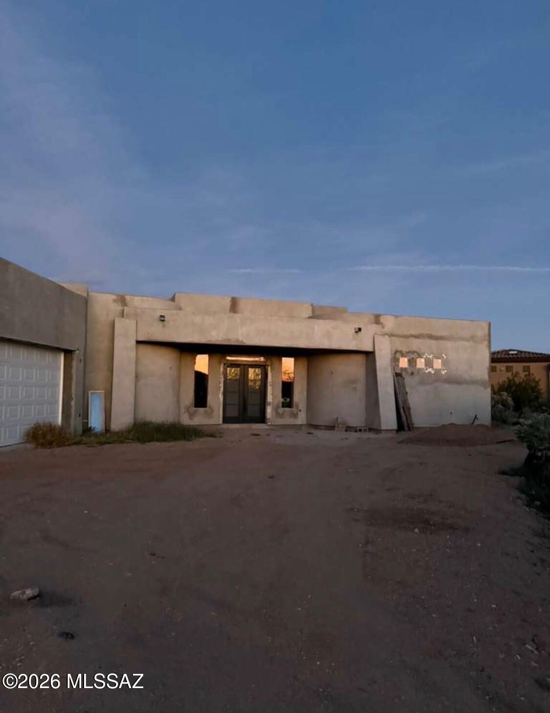 Bring a Modern Southwest vision to life on nearly an acre in the gated community of Stone House. This unfinished new construction home offers contemporary architectural lines and a desert setting with mountain views. The design features an open concept layout, soaring ceilings and a spacious great room planned around a fireplace. A generous, covered patio is designed to extend the living space outdoors, creating a setting for gatherings, outdoor dining and evenings under the Arizona sky. Plans call for tile flooring throughout and a kitchen with expansive granite countertops, bringing together style and everyday functionality. The home is incomplete and requires additional work. It is offered in its current, unfinished, ''as-is'' condition.  An opportunity to complete the remaining work - and bring the home's architectural vision to fruition.