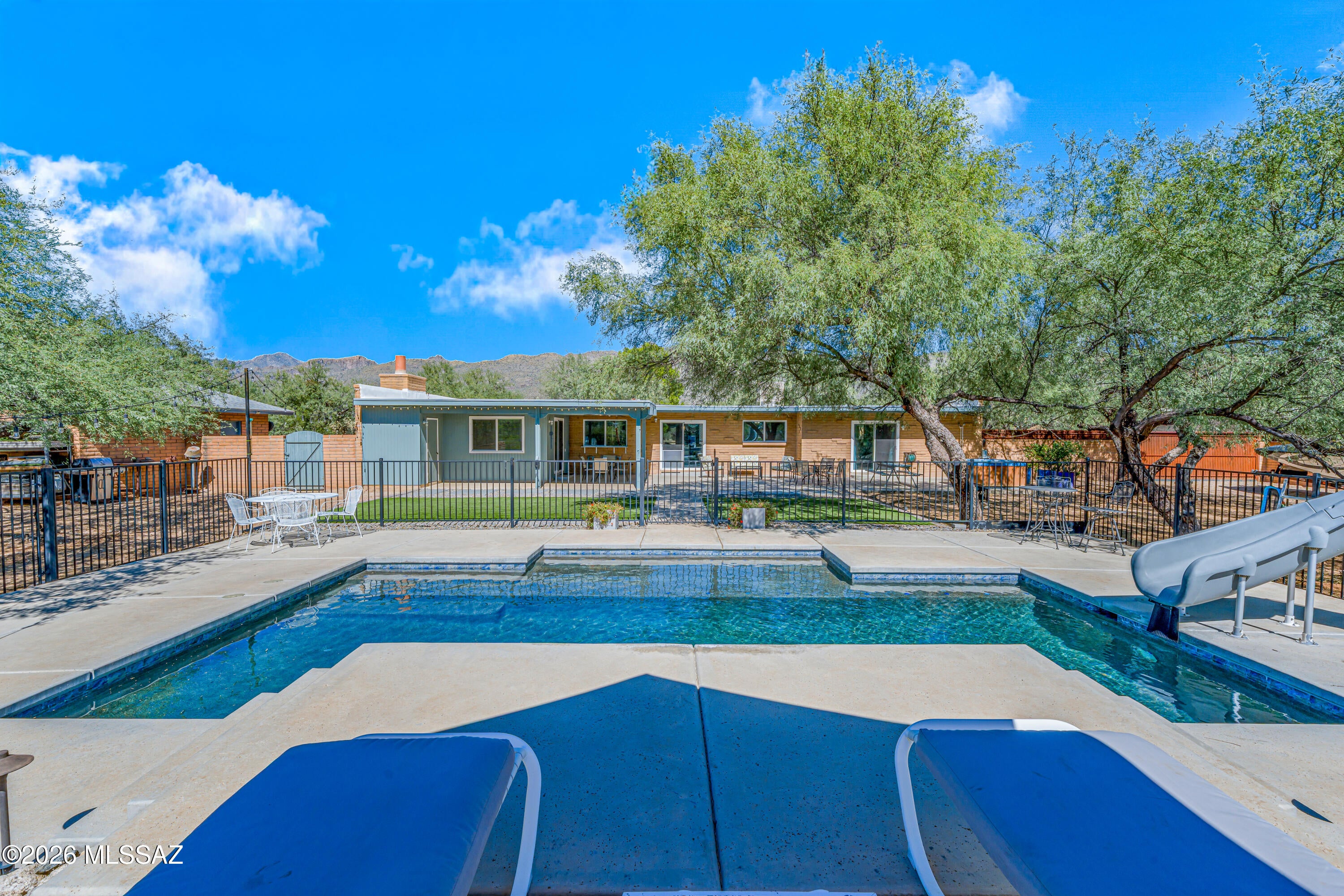 Welcome to a desert oasis in the heart of Tanque Verde Valley! Situated on a spacious 1.12-acre lot, this property offers an exceptional combination of comfort, functionality and Arizona lifestyle enjoyment. The home features 4 bedrooms, 3 bathrooms, two living areas, an updated kitchen with quartz countertops & updated baths with marble countertops & shower surrounds. Additional features include 24'' x 24'' tile flooring throughout & vinyl framed, dual-pane windows. Enjoy the PebbleTec-finished pool, complete with a lagoon-style design, slide & surrounding concrete decking. Mature trees & artificial turf create a private outdoor setting, complemented by corrugated metal fencing around the rear yard with a sliding gate. Room for RV/ boat. Voluntary HOA. Tanque Verde Schools! Owner/ Agent.