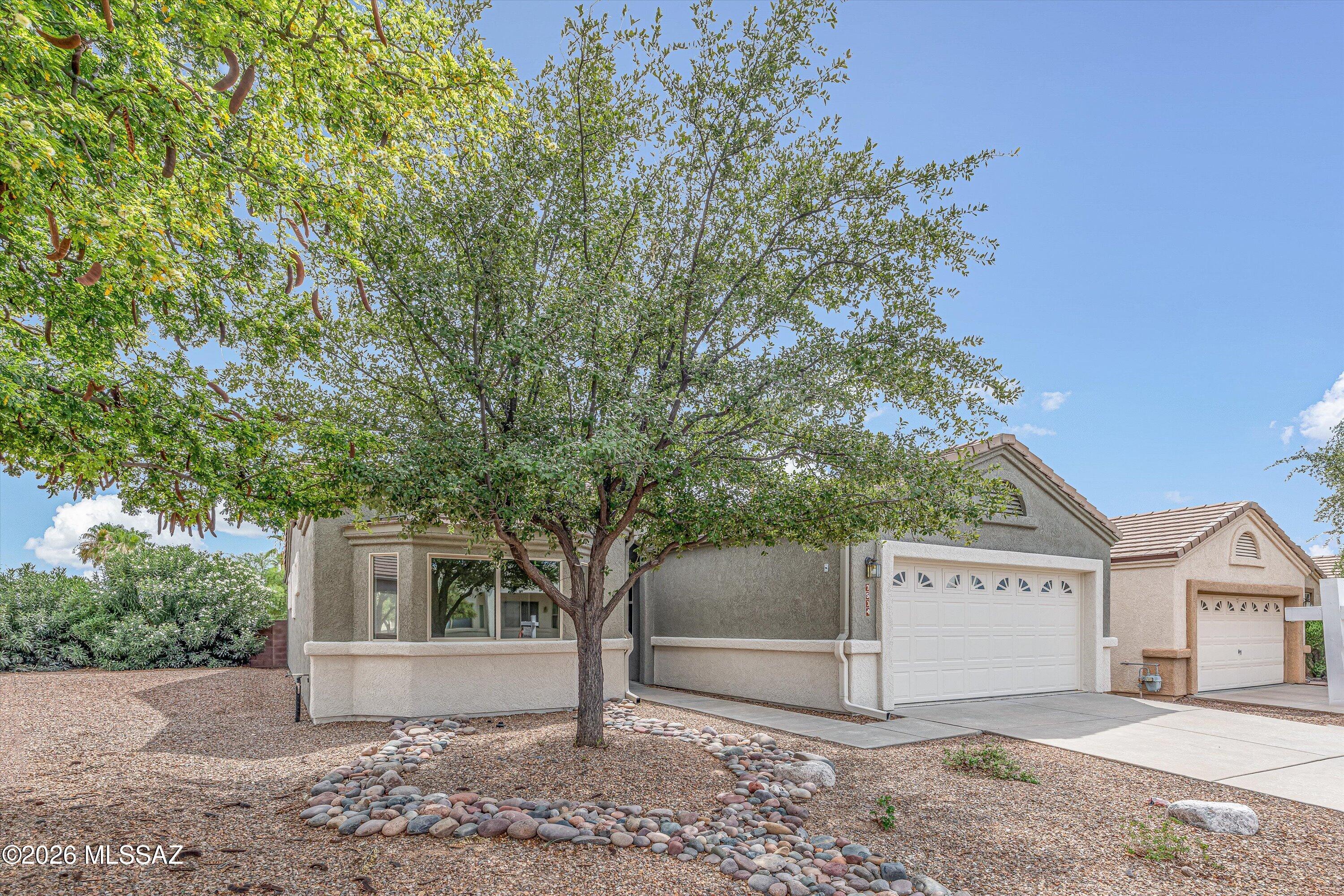 Beautiful 3 BD, 2 BA home in a desirable gated 55+ community offering a plethora of activities and amenities to enjoy an active AZ lifestyle. The spacious primary suite features an ensuite bathroom, walk-in closet, and an additional flex room. The inviting living area includes a cozy gas fireplace, perfect for relaxing evenings. Enjoy the convenience of an interior laundry room and a 2-car garage complete w/ a utility sink, workbench, and built-in storage cabinets. This home offers added privacy w/ only one neighbor on the west side. Recent updates include fresh exterior paint, HVAC replaced in 2023, and a new water heater in 2026. Stone flooring flows throughout the living areas, w/ LVP in the bedrooms for comfort and style. A wonderful opportunity to enjoy low-maintenance lifestyle!
