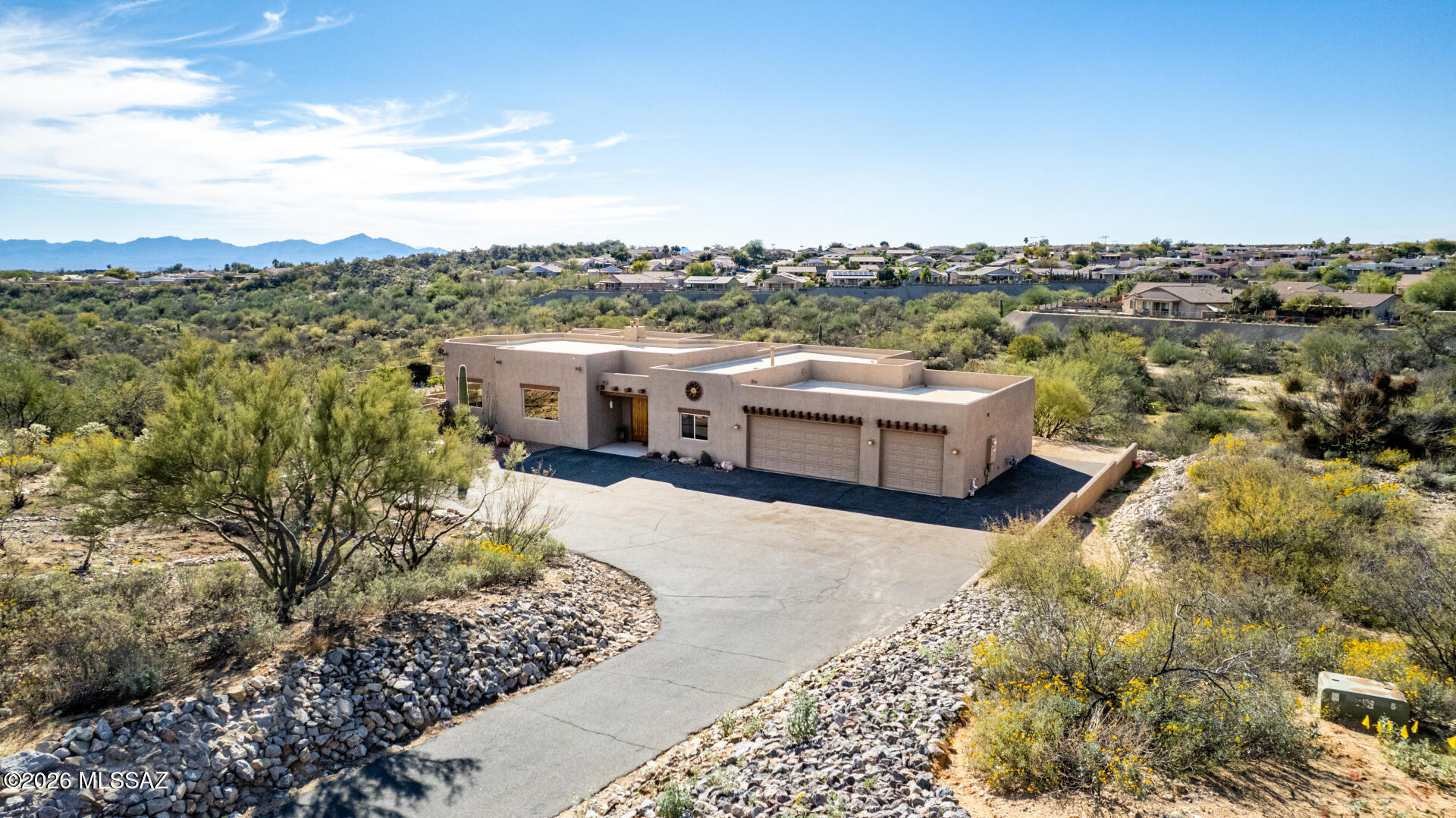 VIEWS, VIEWS, VIEWS! Private retreat in Oro Valley with stunning new landscaping situated on 1.819 acres, surrounded by more than 100 acres of natural open space for exceptional privacy and scenic desert views. This amazing home offers 3,437 sq ft and includes 5-bedrooms, 3-bathrooms, 2 fireplaces, a great room, living room, an oversized 3-car garage, and much more!

The open-concept layout features a great room with soaring ceilings and a striking double-sided fireplace, along with a formal dining area and expansive windows that capture the surrounding landscape. 

The chef's kitchen is designed for both everyday living and entertaining, complete with a large island with a breakfast bar for casual dining, granite countertops, lots of ample cabinetry, newly installed SS refrigerator & dishwasher (2025), a walk-in pantry, and gorgeous views of the Catalina mountains. 

The luxurious primary suite is a true retreat with its own fireplace, plush carpeting, a large walk-in closet, private patio access, and spa-like en-suite bathroom featuring dual vanities, an oversized tile walk-in shower, and a jetted soaking tub. The remaining bedrooms are ample size with soft carpeting. Two bedrooms share a Jack-n-Jill bathroom. 

Step outside to an expansive covered patio ideal for outdoor dining and entertaining. Relax in the hot tub while enjoying mountain views and Arizona's spectacular star-filled skies. The yard has been thoughtfully designed with space for a future pool.
Additional highlights include rolling shutters on all windows, custom closet systems throughout, ceiling fans, a fire sprinkler system, and an oversized 3-car garage with workshop space and evaporative cooling. 

The beautifully landscaped grounds feature low-care desert plantings, decorative gravel, and drip irrigation.

Located adjacent to a wash and bordering common area for added privacy, with miles of Oro Valley biking and hiking trails just outside your door and shopping only minutes away. A rare opportunity to enjoy peaceful desert living with convenient access to town amenities.