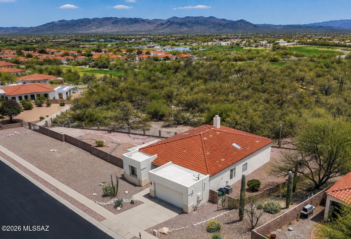 Perched on an elevated .33-acre lot, one of the  largest in the subdivision, this single-family home captures breathtaking mountain and city views that truly set it apart. Enjoy sweeping desert panoramas by day and sparkling city lights at night from this premium homesite. Inside, the home features a desirable split floor plan with 3 bedrooms plus a den 2 bath, offering flexible space for a home office or guest area. Neutral interior paint provides a clean, move-in-ready backdrop that complements any style. The layout is both functional and comfortable, designed for everyday living and easy entertaining. Enjoy access to outstanding community amenities including a pool, fitness center, golf, and a clubhouse with restaurant and bar, resort-style living right to your neighborhood. The oversized lot offers extra privacy and room to create your ideal outdoor living space  perfect for taking full advantage of the stunning views and Tucson sunsets.

Residents enjoy access to outstanding community amenities including a pool, fitness center, golf, and a clubhouse with restaurant and bar, bringing resort-style living right to your neighborhood.