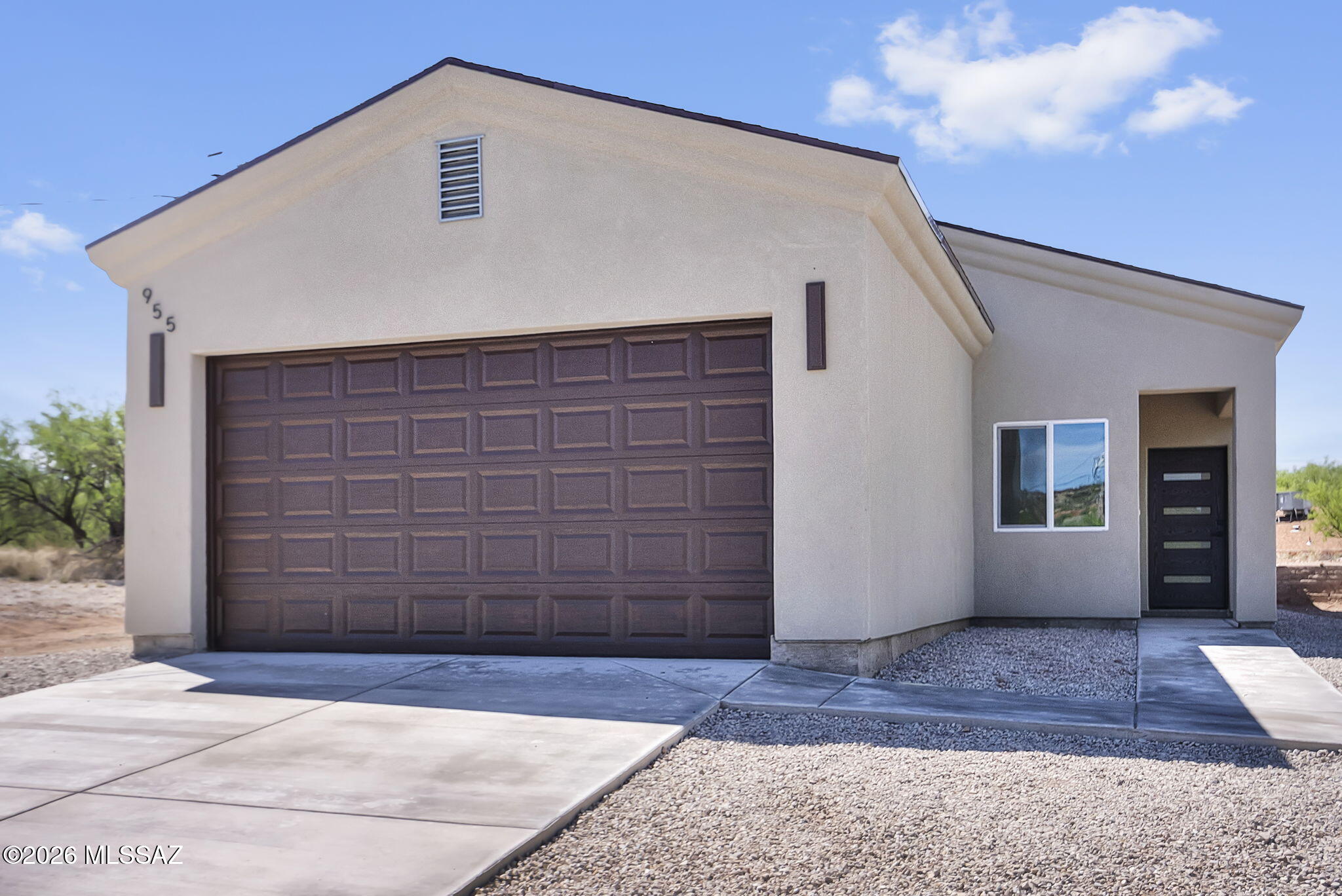 Tucked away on a private cul-de-sac, this beautifully designed home at 955 Tecla Court in Rio Rico offers the perfect blend of modern style, comfort, and space. Situated on a generous 0.46-acre lot, the property provides a rare opportunity to enjoy both privacy and usability. As you step inside you are greeted with an open-concept floor plan that seamlessly connects a spacious living and dining area, creating a bright and airy atmosphere perfect for everyday living and gatherings. Elegant ceramic tile flooring flows throughout the home, complemented by sleek black finishes and contemporary light fixtures. The kitchen is thoughtfully designed with both style and functionality in mind. Featuring stunning quartz countertops, stainless steel appliances, soft-closing cabinetry, and a convenient pantry. Both bathrooms are appointed with modern upgrades, including walk-in tile showers, dual flush toilets, and anti-fog, wall-mounted lighted vanity mirrors. With its combination of stylish finishes, practical layout, and expansive lot, this home delivers exceptional value in a peaceful setting. Don't miss the opportunity to make this move-in-ready property your own.