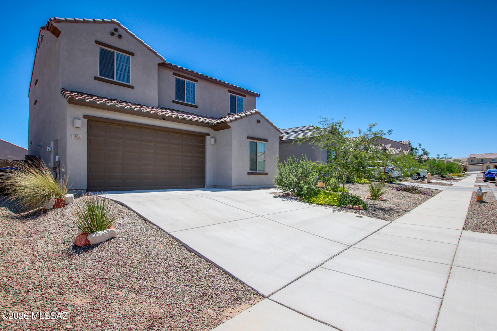 Beautifully maintained newer-built home in Rancho Sahuarita offering modern comfort & move-in-ready convenience. Versatile floor plan features a downstairs bedroom & full bath, ideal for guests, office, or flex space. Bright open-concept living flows into a stylish kitchen with Whirlpool appliances, abundant cabinetry & walk-in pantry. Upstairs offers a spacious loft, laundry room, relaxing primary suite with mountain views, plus two additional bedrooms. Backyard is ready for your personal touch. Includes refrigerator, washer, dryer & two-car garage. Enjoy Rancho Sahuarita amenities including multiple community clubs, pools, jacuzzis, Sahuarita Lake, walking paths, green parks & moreâ€”all included in the affordable HOA.