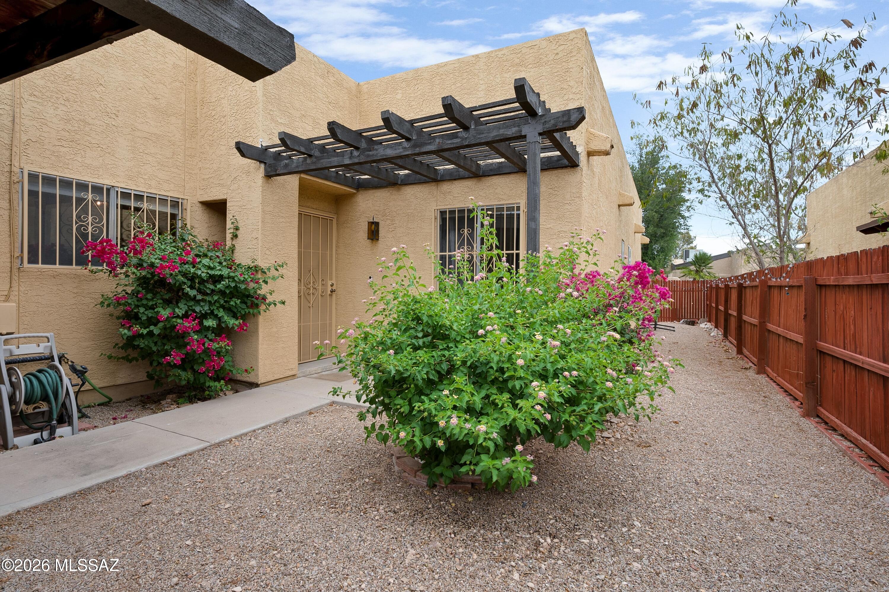 Re-plumbed in 2025 with a 6-year-old HVAC system & new on-demand water heater, this townhome offers important big-ticket updates already completed. Welcome to Ladera Brisas, a charming Spanish style community conveniently located near downtown Tucson, Pima Community College West, the University of Arizona, walking trails, shopping, dining, and public transportation. The home features a family room with high ceilings, a fireplace, dining area, and warm wood look vinyl flooring. The kitchen includes granite countertops, and the bathroom offers a double sink vanity with quartz countertop. Additional highlights include an attached 2 car garage, laundry room, two garage storage rooms, and an enclosed gated side yard for privacy and security. Residents also enjoy access to the community pool.