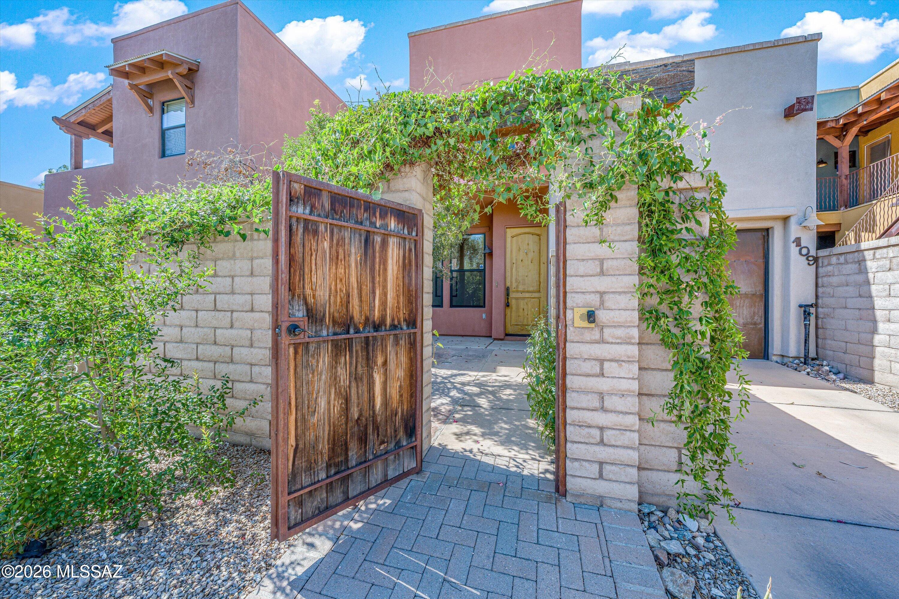 Welcome to this stunning, move-in-ready contemporary townhome located in the highly desirable Miramonte at the River community. Spanning 2,094 square feet, this spacious 2-story residence offers an exceptional open-concept layout perfect for modern living. The main floor flows seamlessly from the bright dining area to a fully equipped kitchen featuring a functional center island, ample cabinetry, and recessed lighting. Relax by the cozy fireplace in the inviting living room, or step outside to enjoy the low-maintenance front and side patio spaces. Upstairs, you will find three generous bedrooms, including a primary suite with a walk-in closet. Convenient location, you are just moments away from premium North Tucson shopping, dining, and the scenic river walk trail