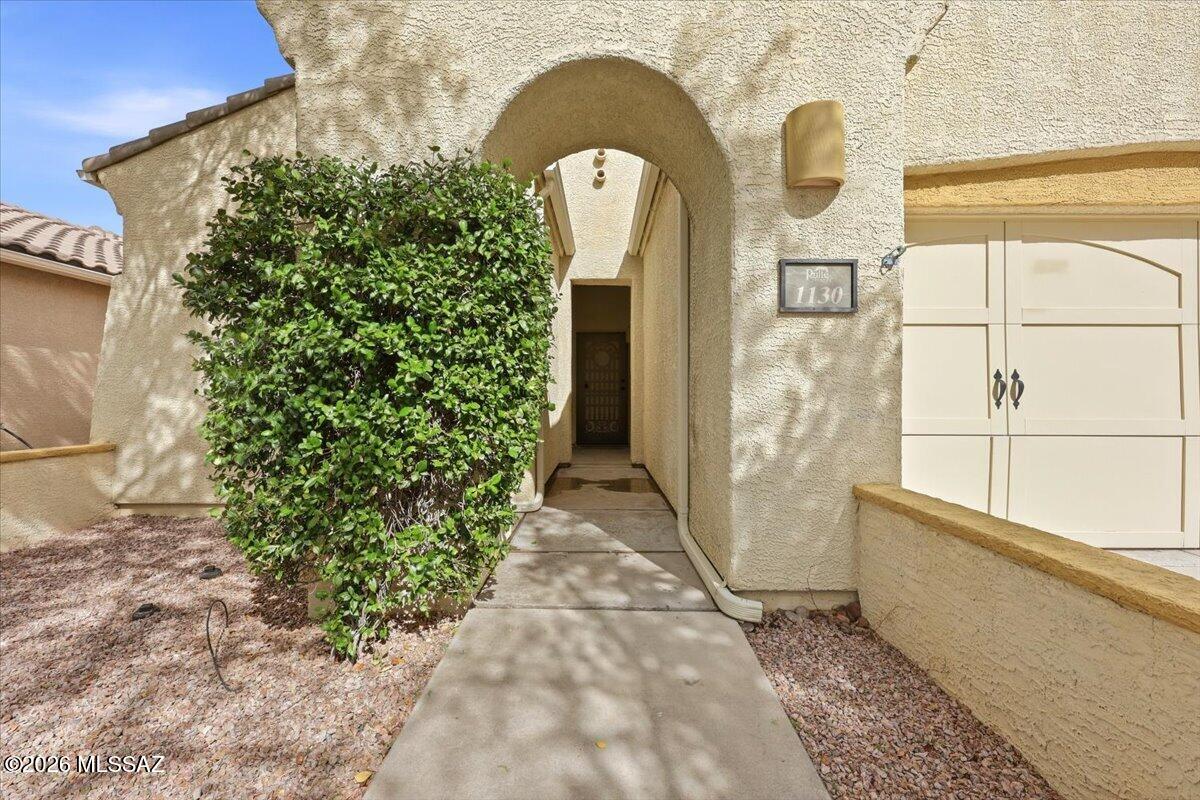 Situated in an established Oro Valley neighborhood just a short stroll from the community park, this clean, well-kept 3BD/2BA + Den home offers 2,100 sq ft of comfortable living space. A gated front courtyard welcomes you in, and the open great room centers on a fireplace, an easy gathering spot for friends and family. The kitchen offers granite counters and staggered-height cabinetry with generous storage. The primary suite opens to the patio and includes a soaking tub, glass-enclosed shower, and large walk-in closet. A den with French doors makes a natural home office, and the front bedroom features an arched window. Out back, the covered patio and extended brick pavers fall into afternoon shade, ideal for winding down at the end of the day, while the block privacy wall and mature landscaping keep the yard private and easy to care for. A laundry room with storage and a 2-car garage with a utility sink complete the home. Well-maintained and ready for your personal touches.