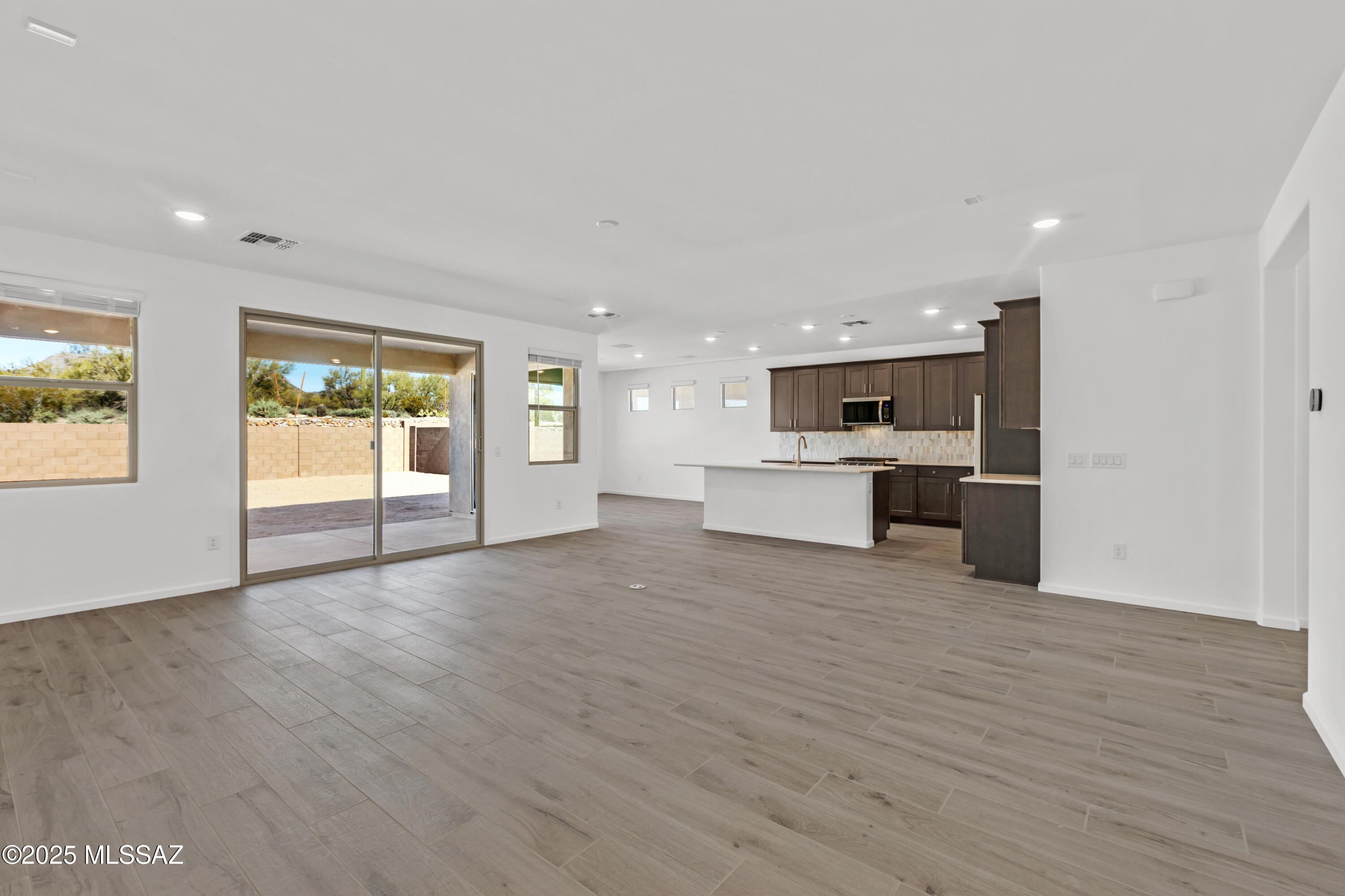 Auburn plan w Desert Modern elevation. Welcome to your dream home featuring open Greatroom concept with Den. Here the heart of your home seamlessly blends the living, dining, and kitchen areas. The stylish kitchen boasts 42'' upper cabinets, gas range, granite countertops, center island & spacious corner walk-in pantry. Owner's suite features huge walk-in closet, vanity with twin sinks, linen closet & walk-in shower. Enjoy the pleasure of outdoor gatherings on the covered back patio. Includes 8' interior doors, Whirlpool Refrigerator, Washer/Dryer, faux wood blinds!! Ready Dec '25.
