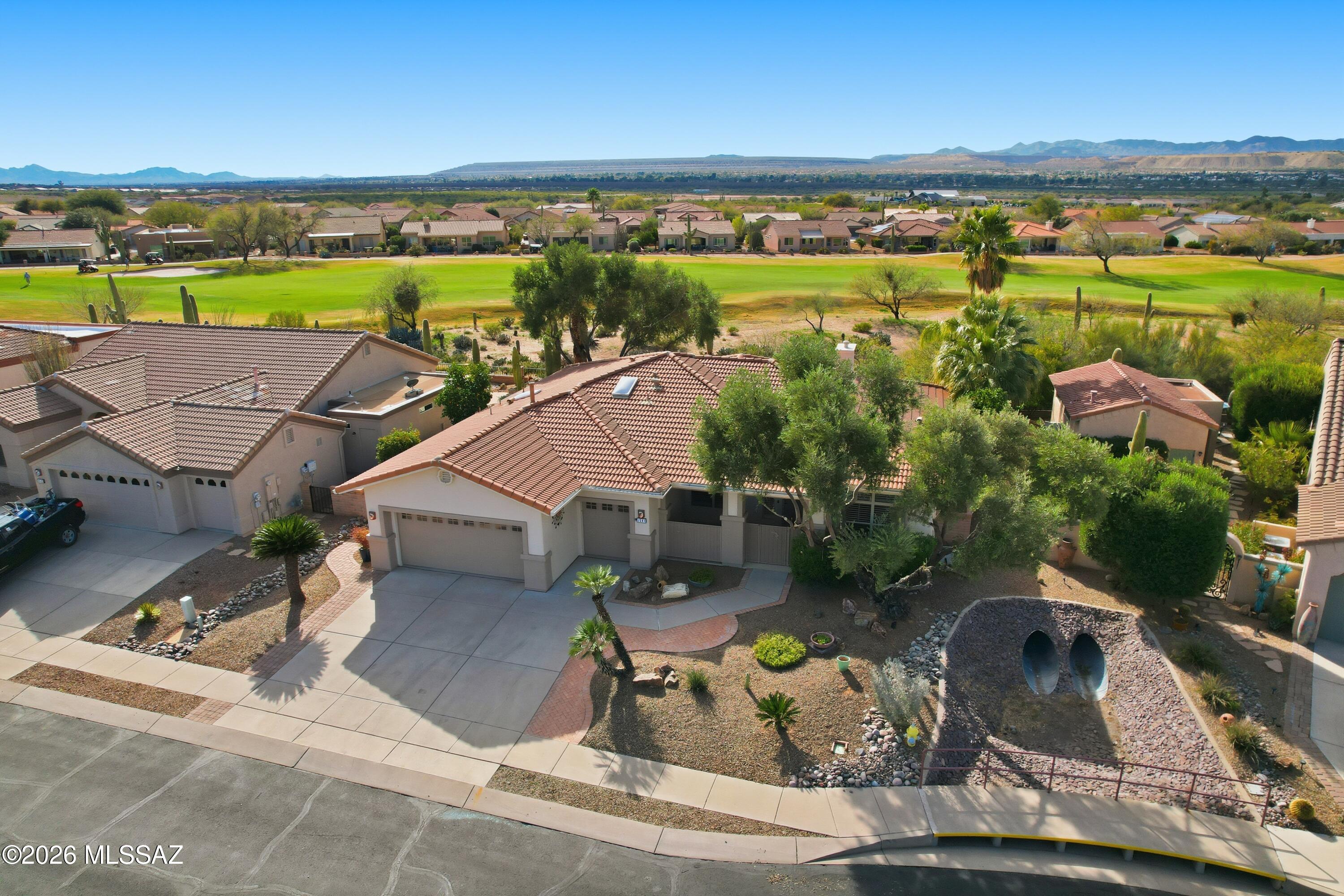 Step into resort living in this stunning 2,193 sq ft Quail Creek home with sweeping golf course and mountain views. Bright, airy spaces feature large windows with plantation shutters, soaring ceilings, and an open floor plan accented with warm Southwest tones. The kitchen shines with stainless steel appliances, Corian counters, built-in double ovens, and a sunny eat-in nook. The luxurious primary suite offers a spa tub and walk-in shower, while guests enjoy a private en-suite retreat. Outdoor living impresses with a Pebble Tec pool, covered patio, and enclosed front courtyard. A 2.5-care garage provides abundant storage and a workbench area. Beautiful landscaping completes this exceptional desert escape . A 2.5-car garage provides abundant storage and a workbench area. Beautiful landscaping completes this exceptional desert escape