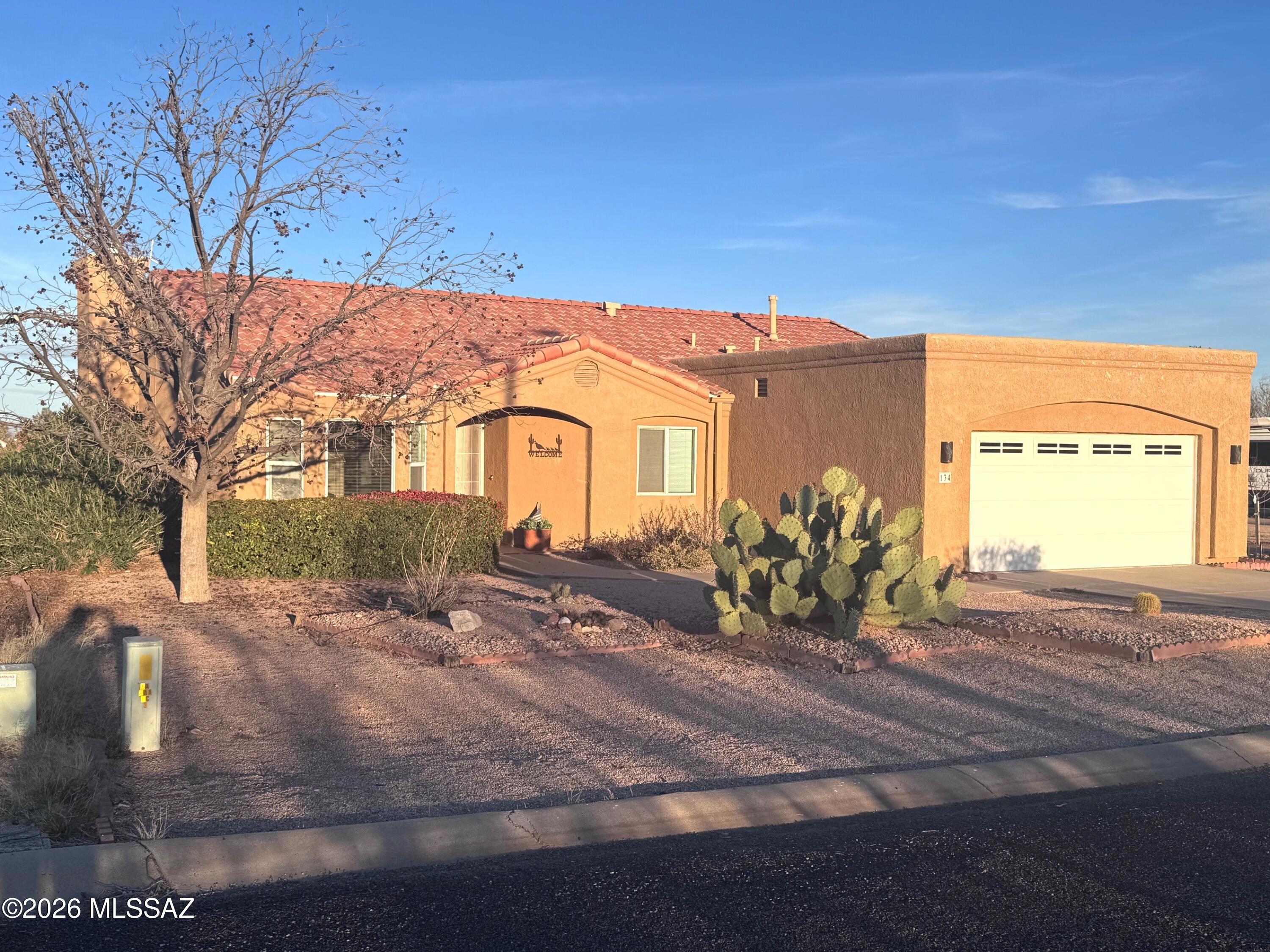 This very nice, well maintained home  overlooks picturesque vineyards with sweeping  views of the Chiricahua and Dos Cabezas Mountains. Enjoy the peaceful ambiance of the Arizona desert, where open skies, and colorful sunrises and sunsets create the perfect backdrop for everyday living. Features include an oversized garage with built-in shelving and workbench. A large covered back patio with tile flooring, hot tub and gas fire table set on natural flagstone-creating an exceptional outdoor living and entertaining space. Inside, the home boasts an open floor plan with a spacious living room and beautiful gas fireplace for those chilly nights, brand-new carpet in both bedrooms, and a large office/exercise room that could easily serve as a third bedroom. A must see to fully appreciate.