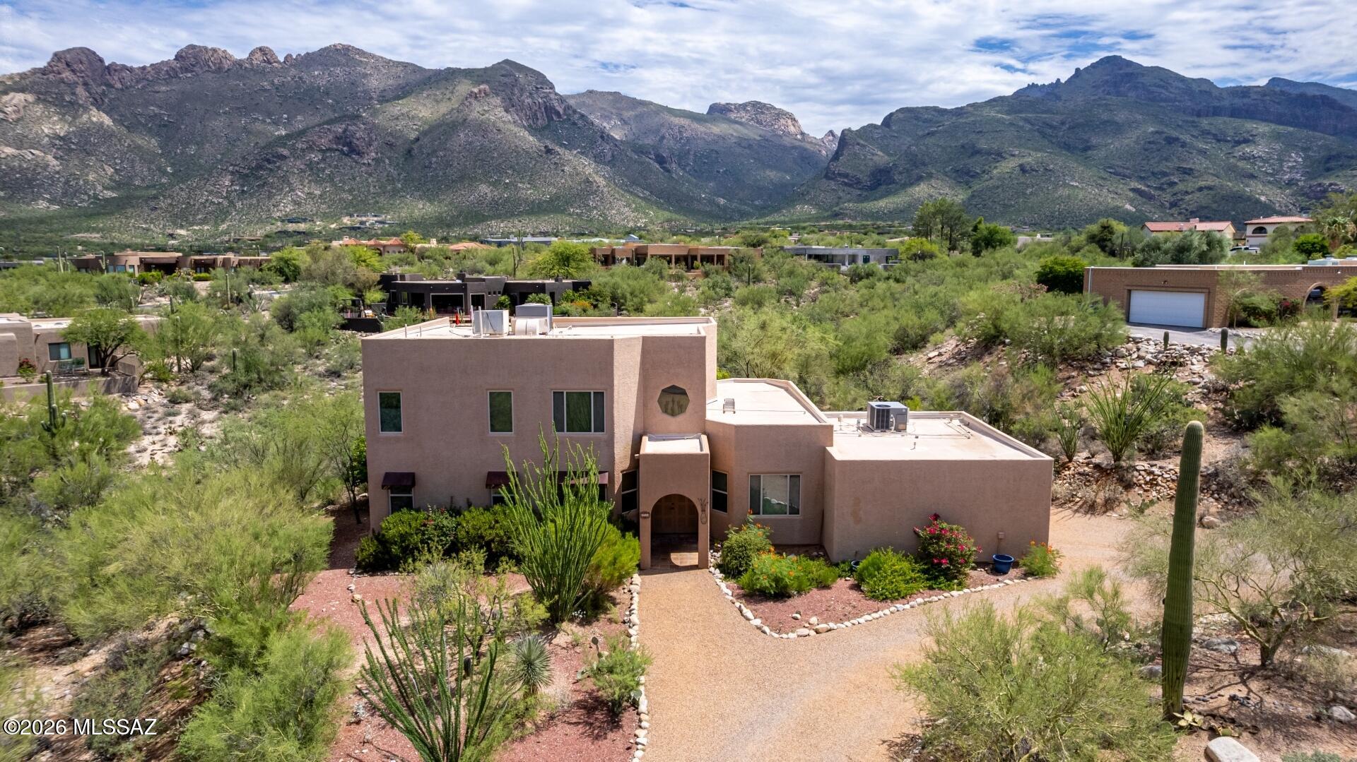 Set on nearly an acre, in the Catalina Foothills' coveted Shadow Rock community, this three-bedroom, two-bath residence pairs mountain views with thoughtfully scaled living space. Twenty-foot open-beam ceilings and walls of glass define the living room, where natural light and polished ceramic flooring create an airy, elevated feel. A separate family room, anchored by a two-way fireplace, extends the living space with quiet versatility, while the formal dining room sets the stage for effortless entertaining.  Upstairs, a private loft offers flexible space for a home office or secondary retreat. Positioned on a generous .83-acre lot with easy access to I-10, fine dining, shopping, and top-rated schools, this home offers a rare balance: Foothills seclusion with everyday Tucson convenience.
