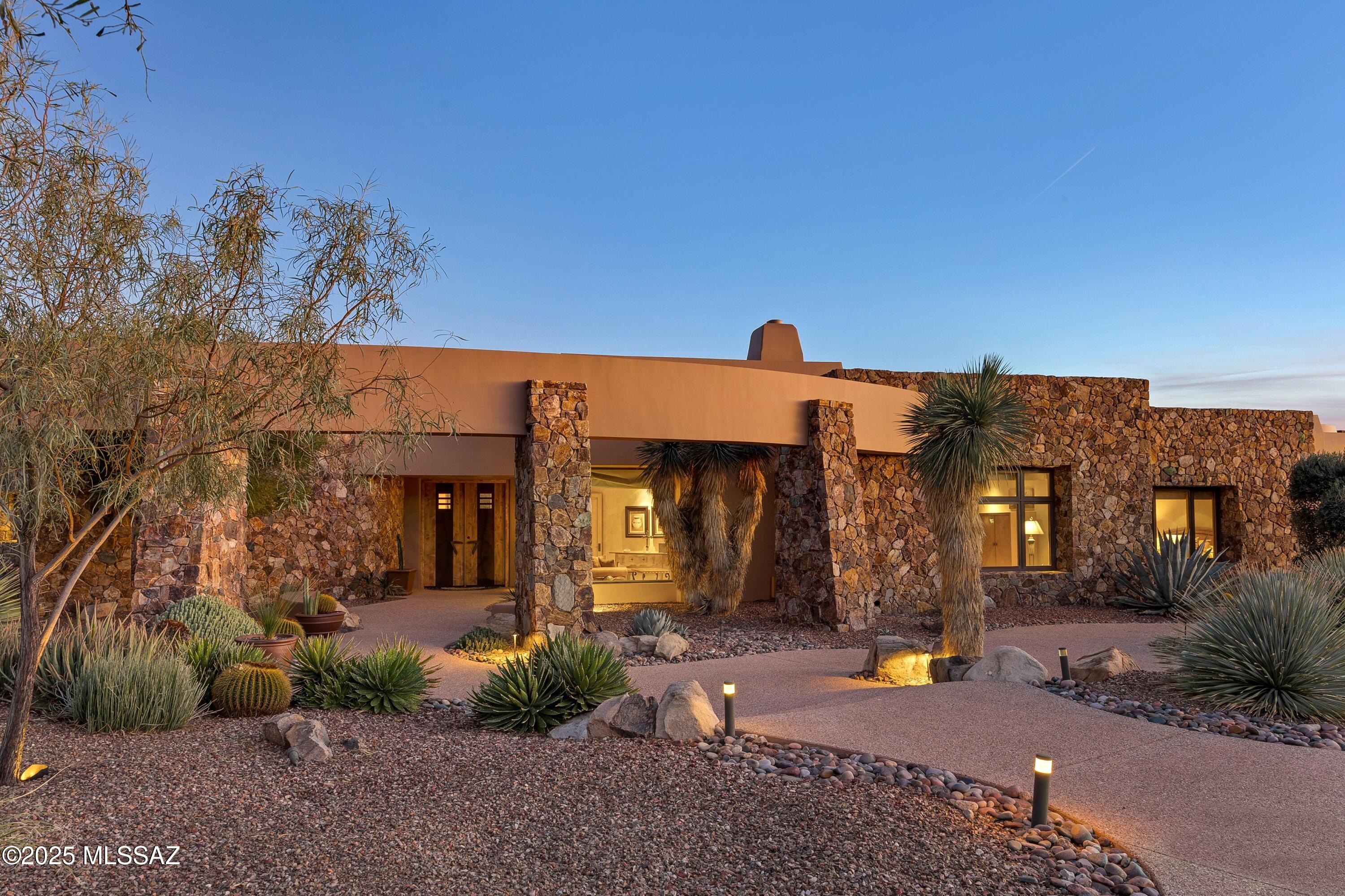 Rock-solid masonry construction meets timeless luxury in this impeccably crafted residence, perfectly positioned along the 17th fairway with sweeping Catalina Mountain and sunset views. Designed by acclaimed architect Ron Robinette with interiors by Lori Carroll, every detail reflects uncompromising quality and thoughtful design. This home offers a furnished designer interior, that seamlessly blends refined elegance with comfortable everyday living. Expansive living spaces are anchored by multiple fireplaces, high ceilings, and seamless indoor-outdoor flow. The split-bedroom layout provides privacy, while generous gathering areas are ideal for entertaining. Outdoor living is elevated with a pool, spa, and cascading water feature, lush citrus trees, a rooftop deck with fireplace capturing panoramic views of the golf course and surrounding mountains, and an outdoor built-in BBQ area perfect for alfresco dining.

Set within the guard-gated Stone Canyon community, this property delivers privacy, architectural integrity, and a truly exceptional desert lifestyle -  An elevated retreat in every sense.